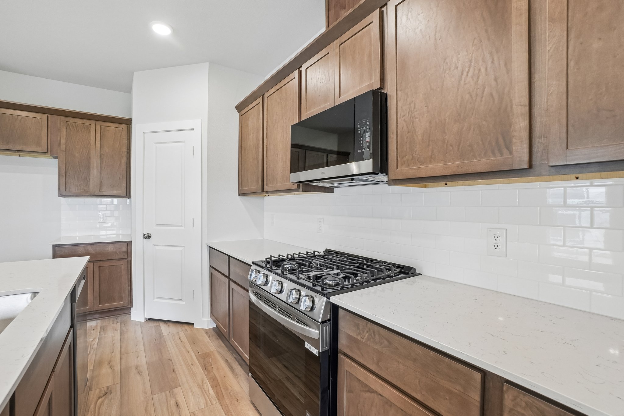 A kitchen with wooden cabinets.