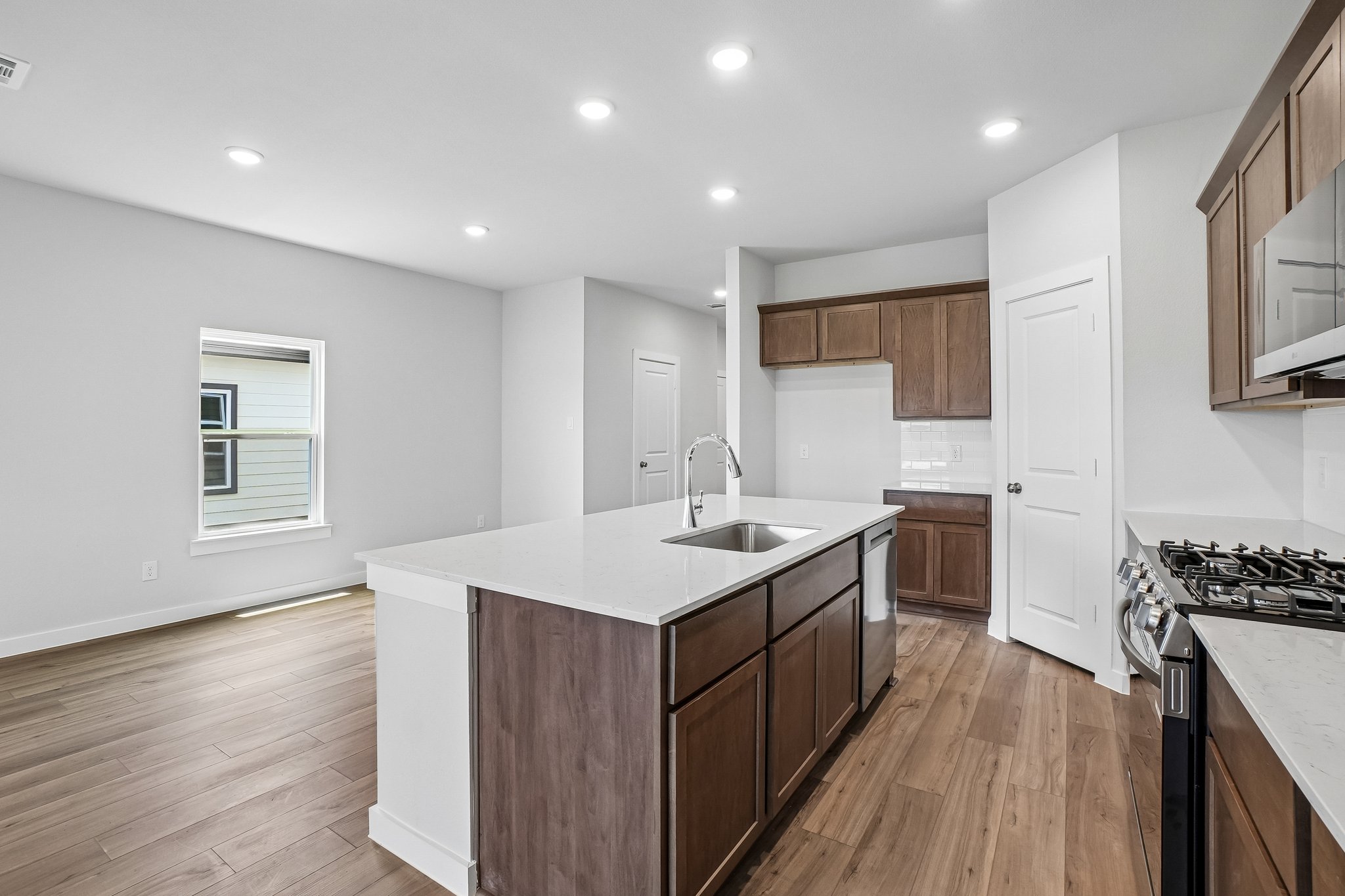 A kitchen with wooden cabinets.