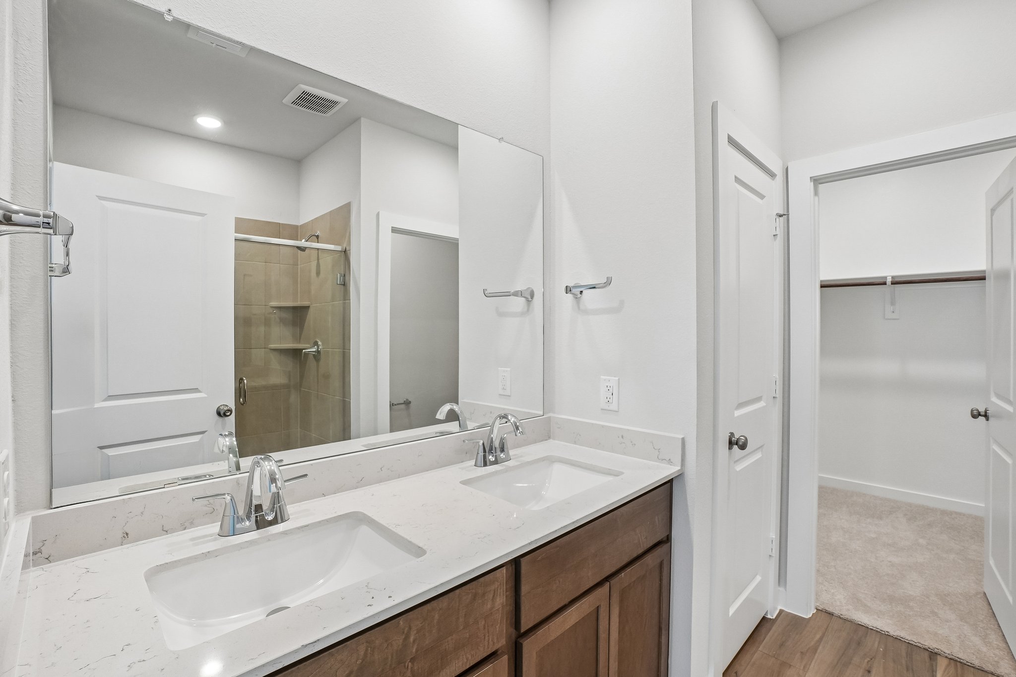 A bathroom with a large mirror.