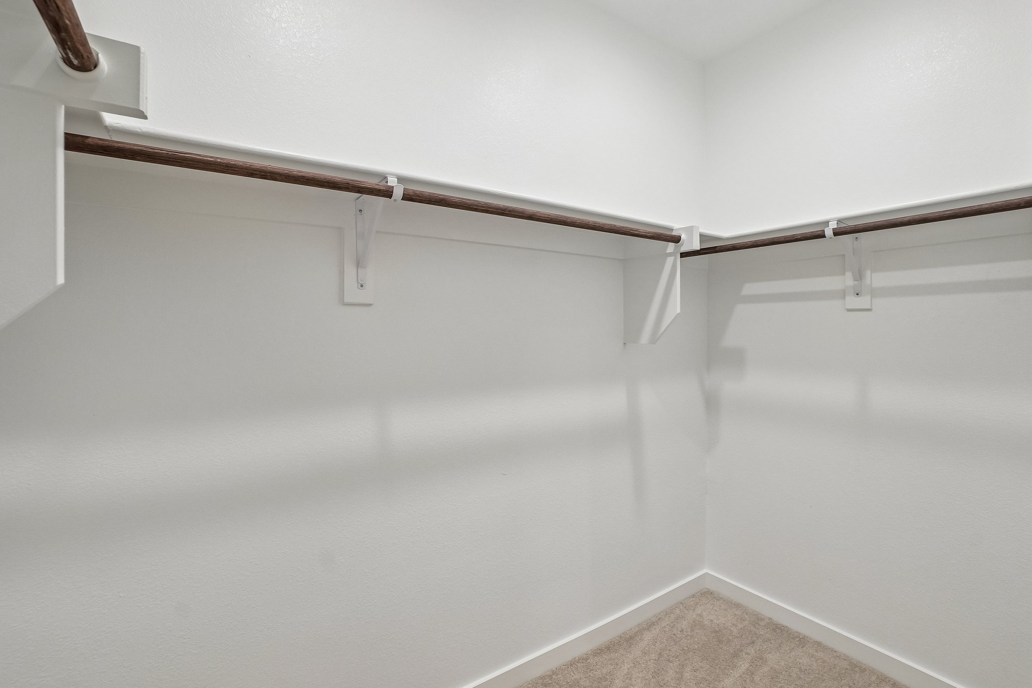 A white wall with a metal railing.