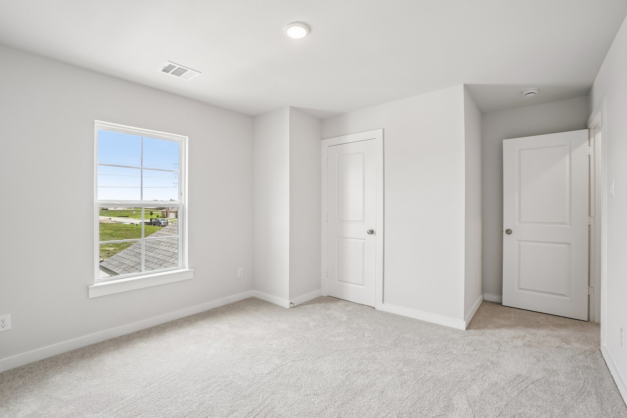 A room with white walls and a window.