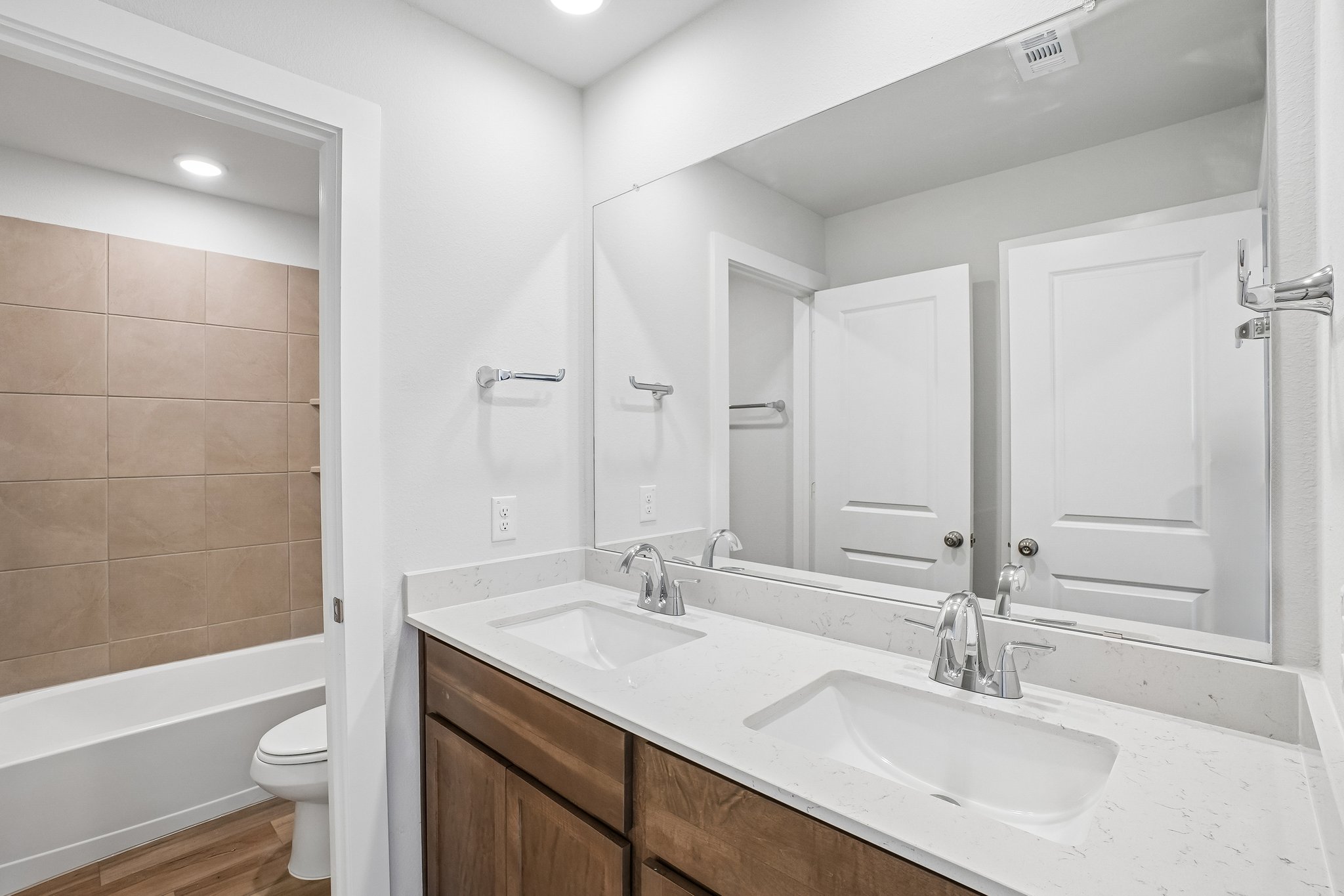 A bathroom with a tub sink and toilet.