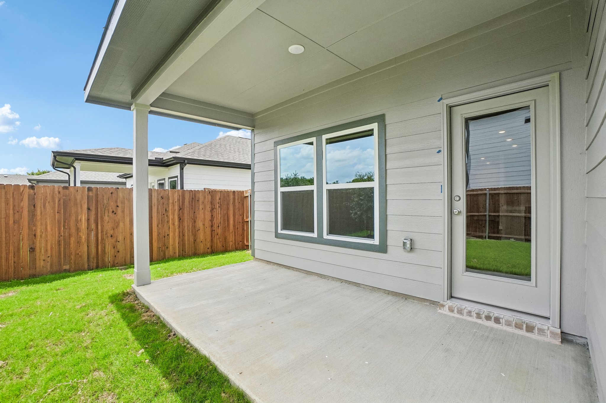 A house with a fence and grass.