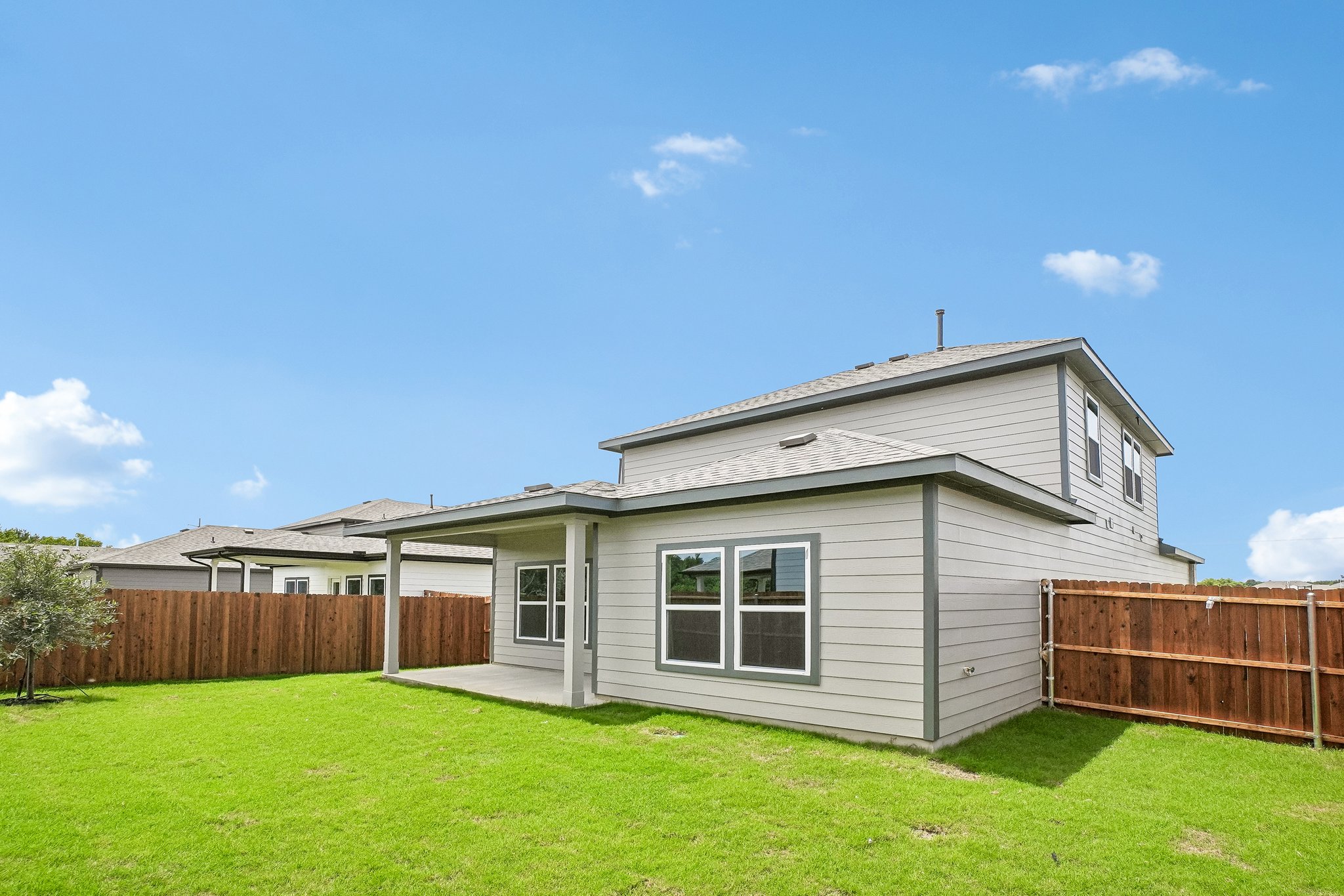 A house with a fence and grass.