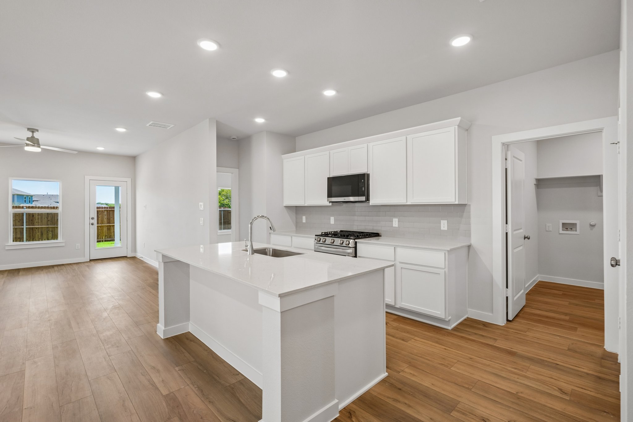 A kitchen with white cabinets.