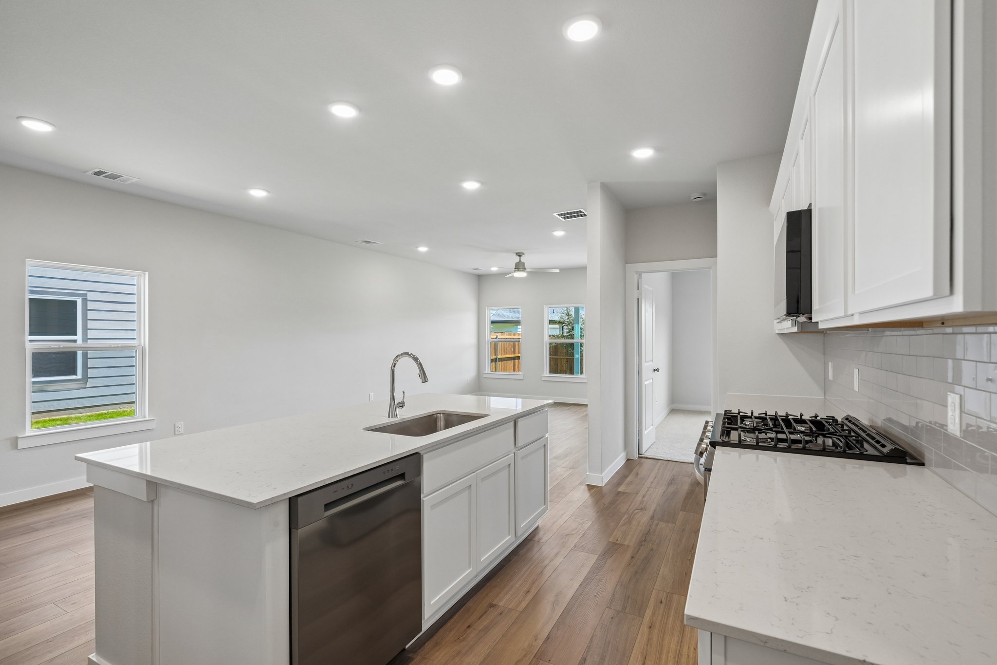 A kitchen with white cabinets.