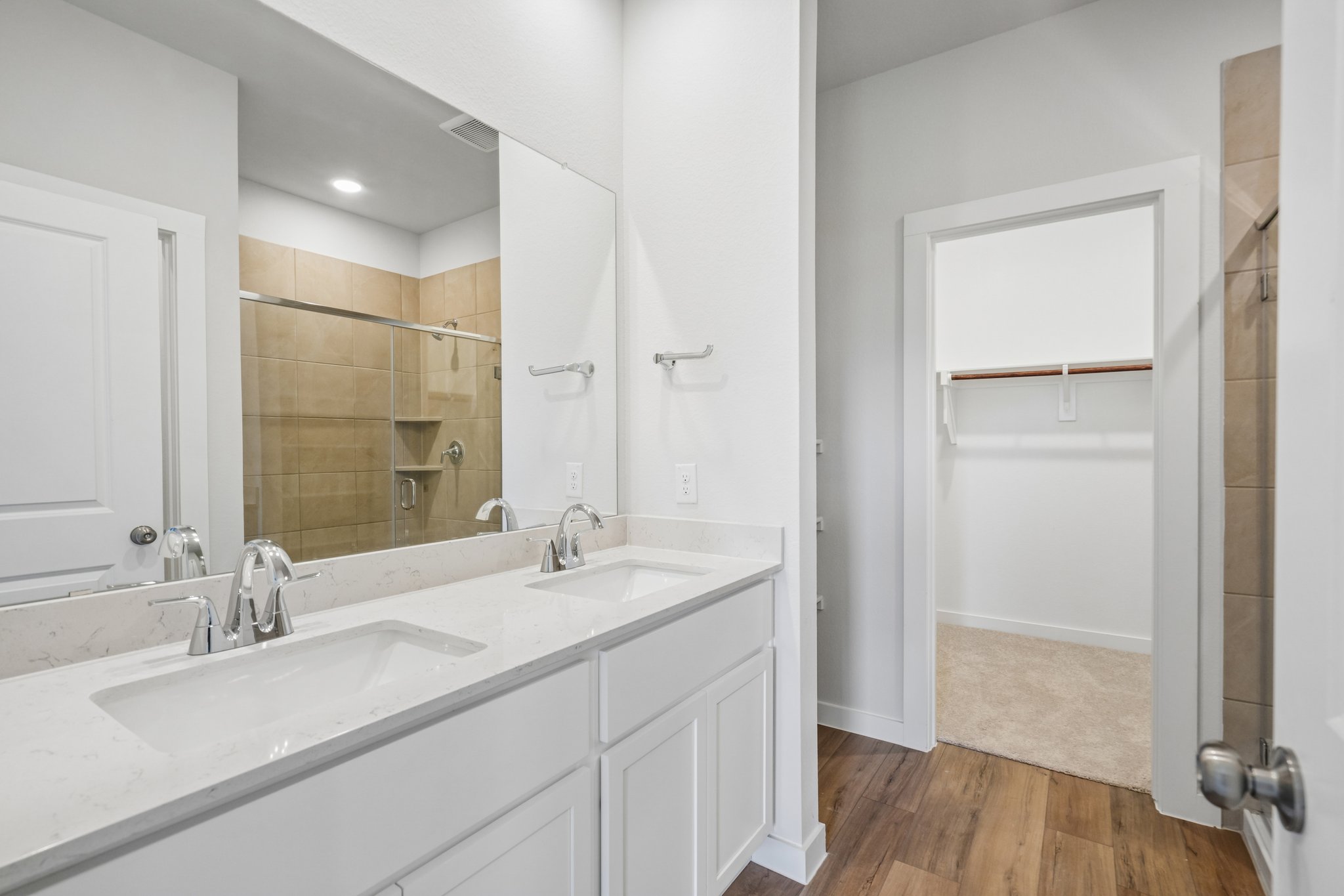 A bathroom with a large mirror.