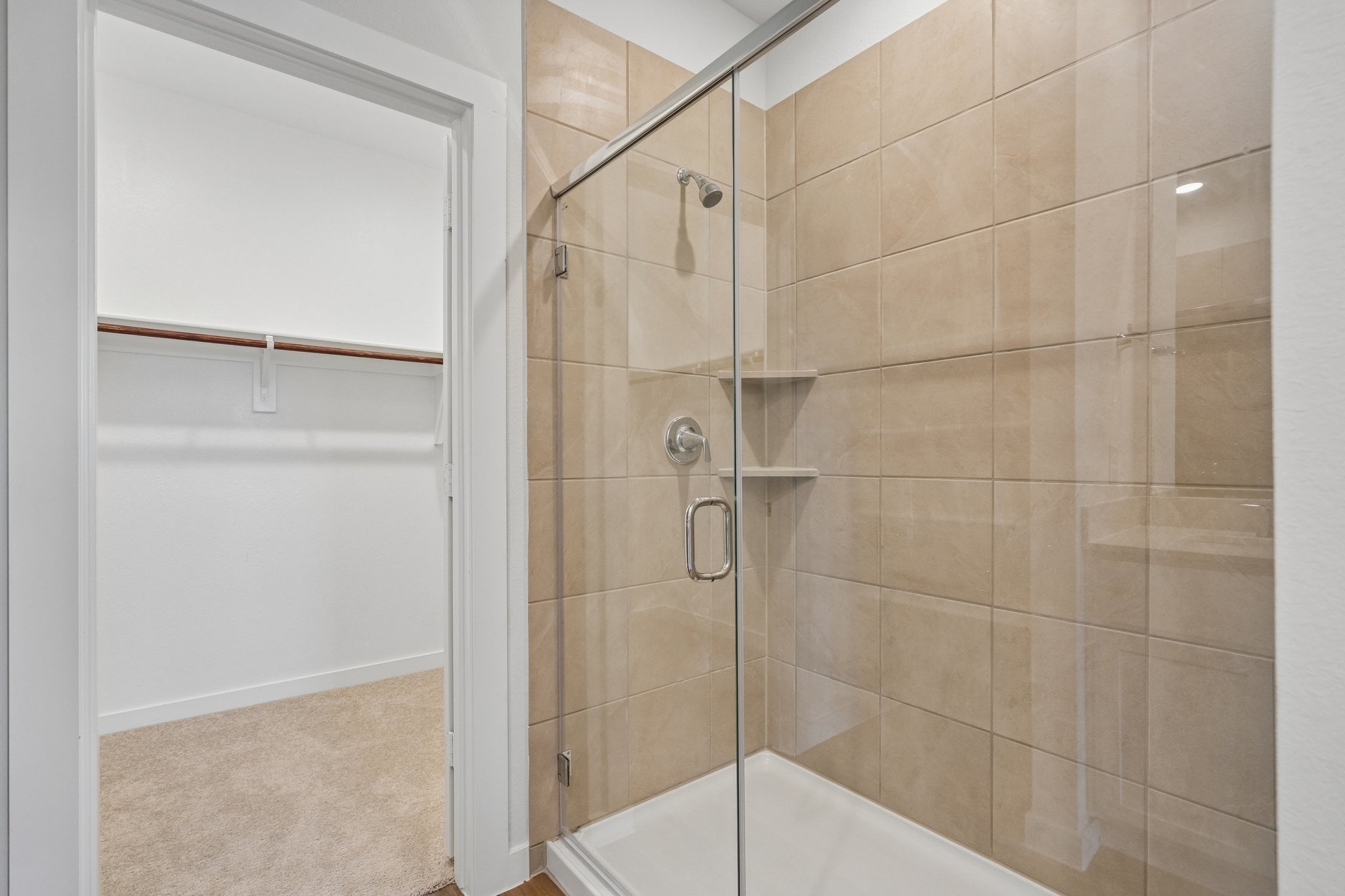 A shower with a glass door.