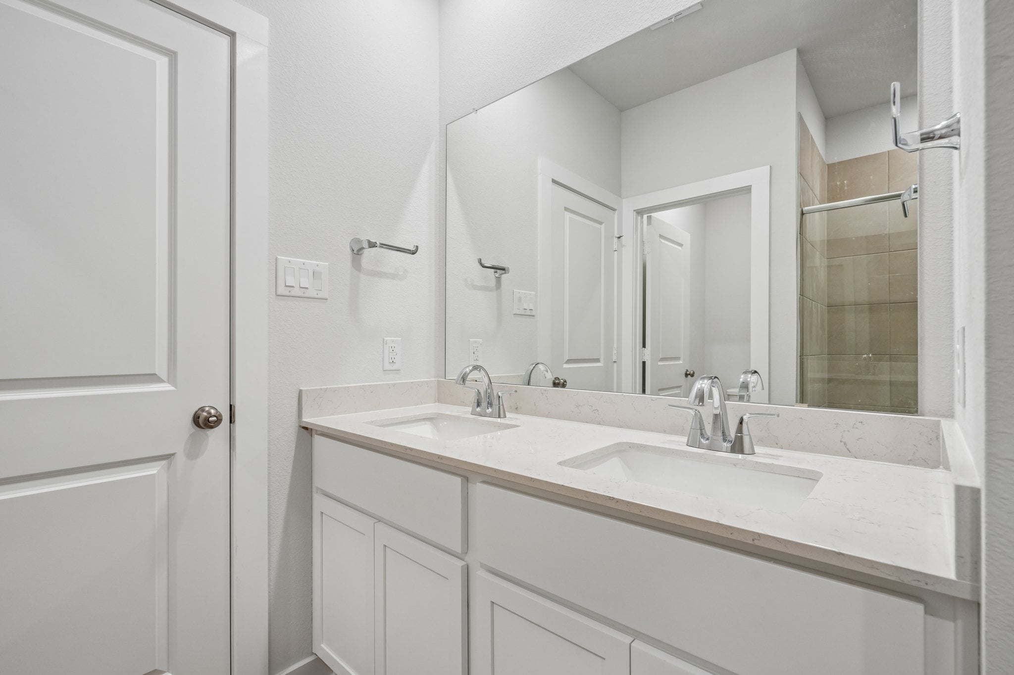 A bathroom with a large mirror.