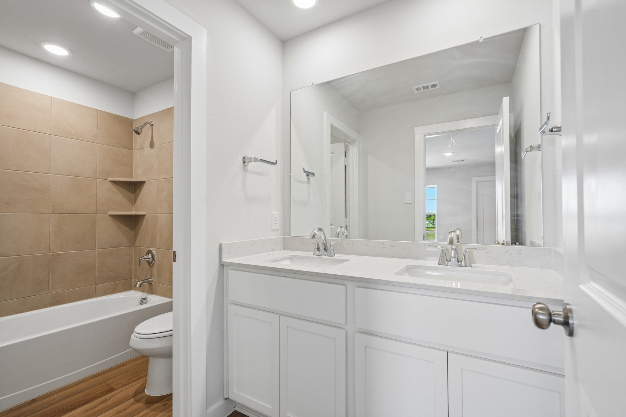 A bathroom with a tub sink and toilet.