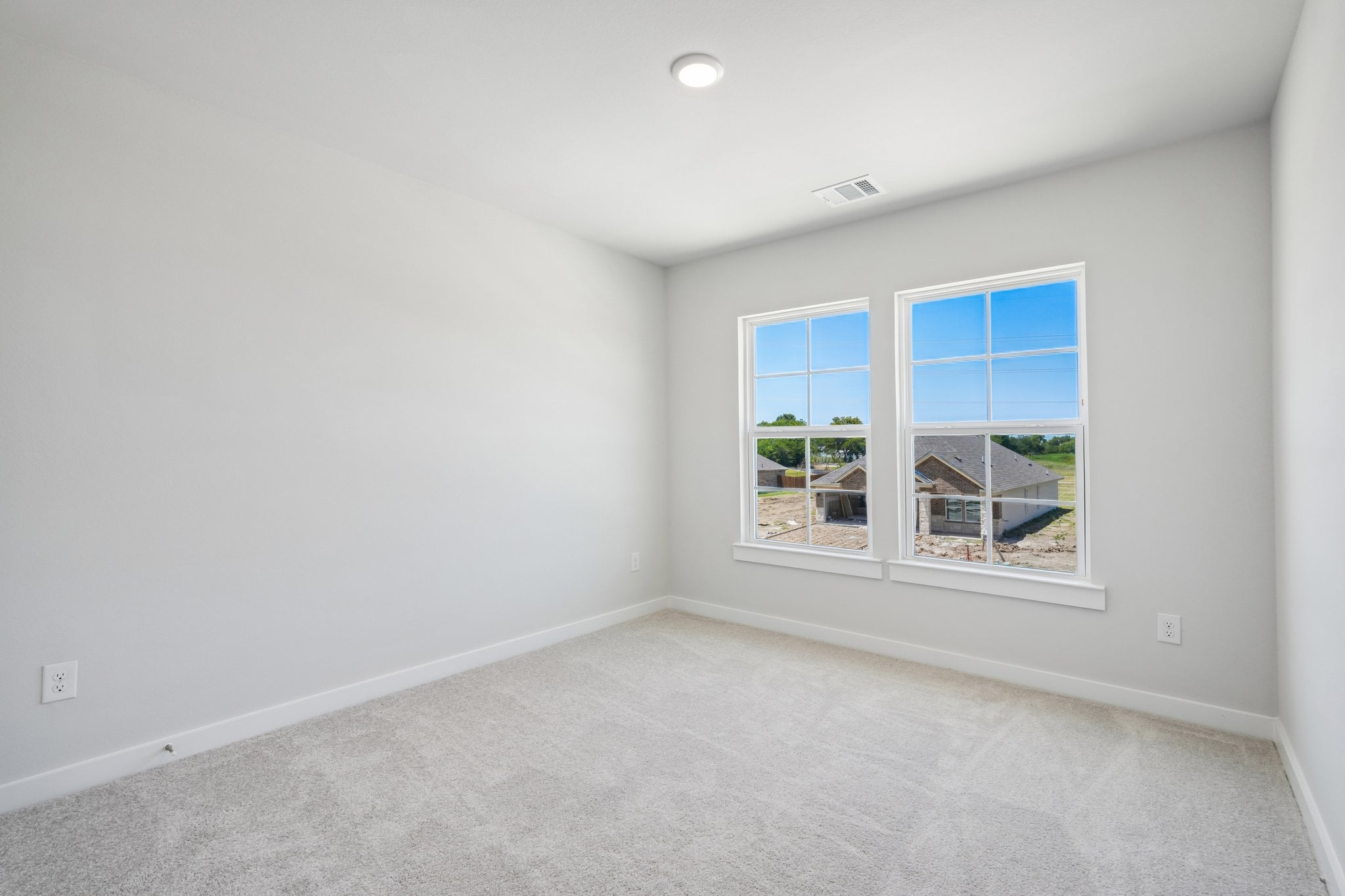 A room with a window and a carpet.