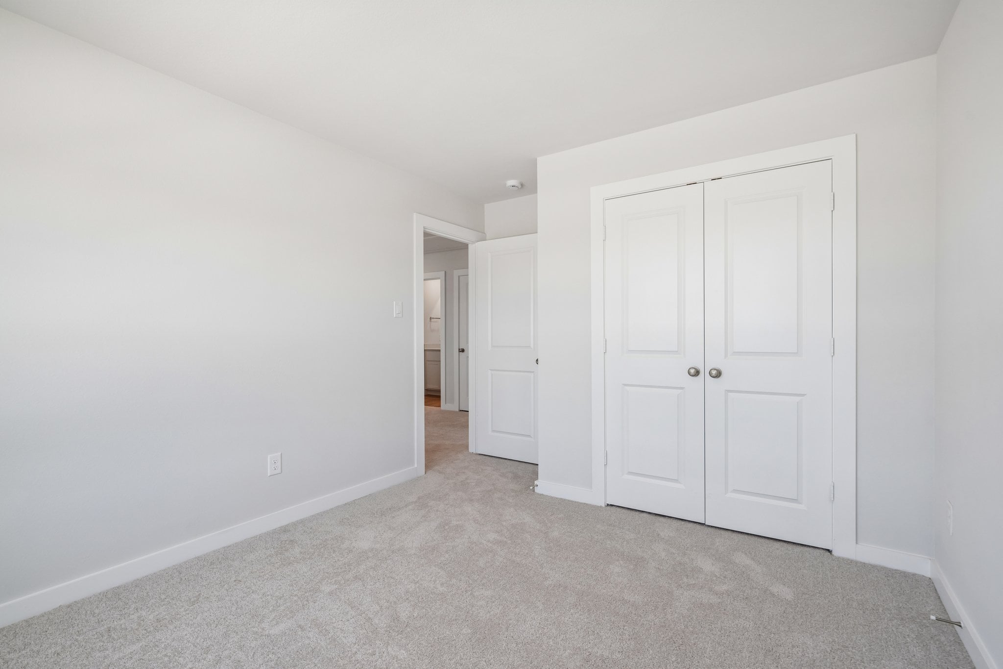 A hallway with white doors.