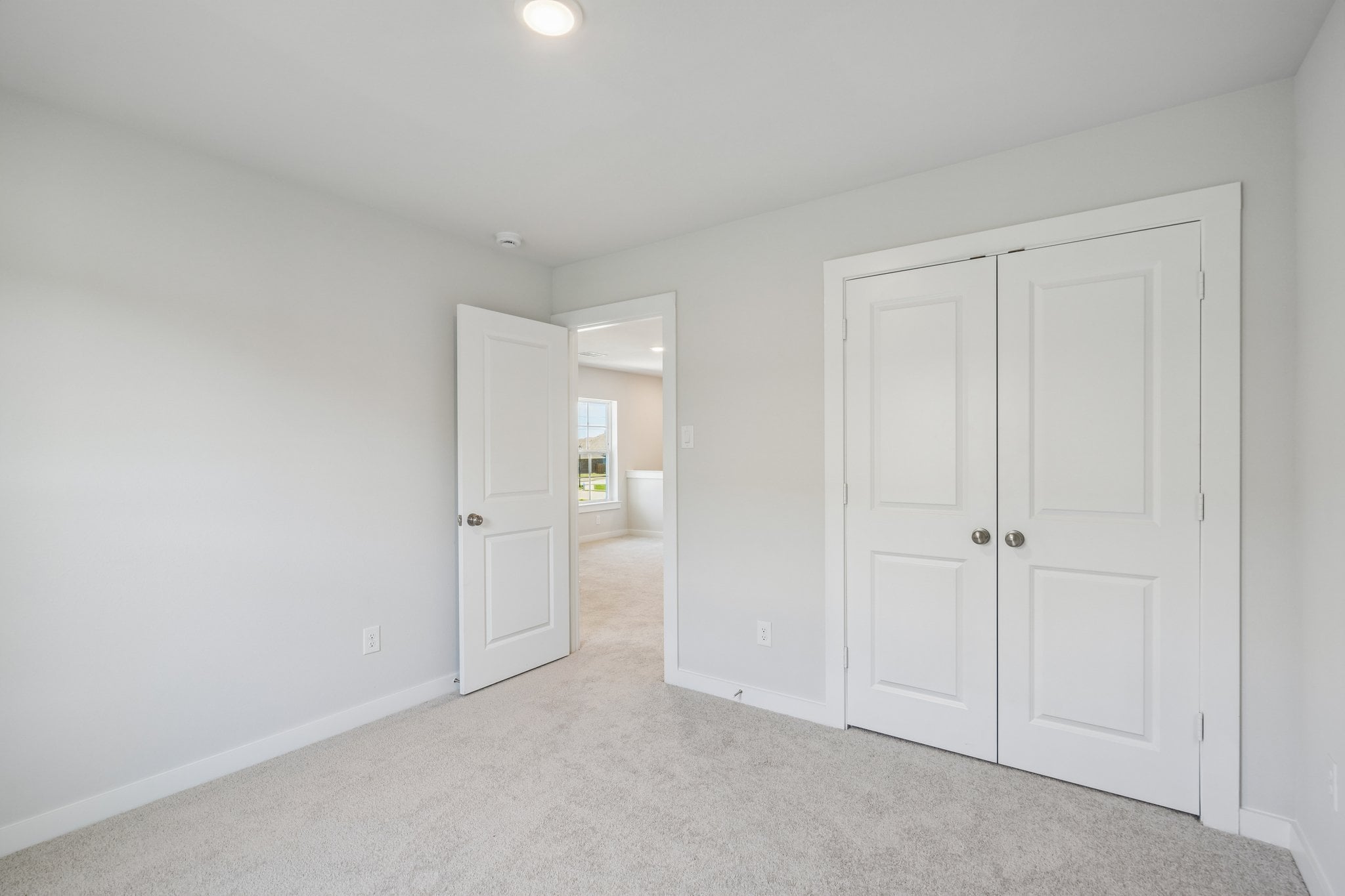 A hallway with white doors.