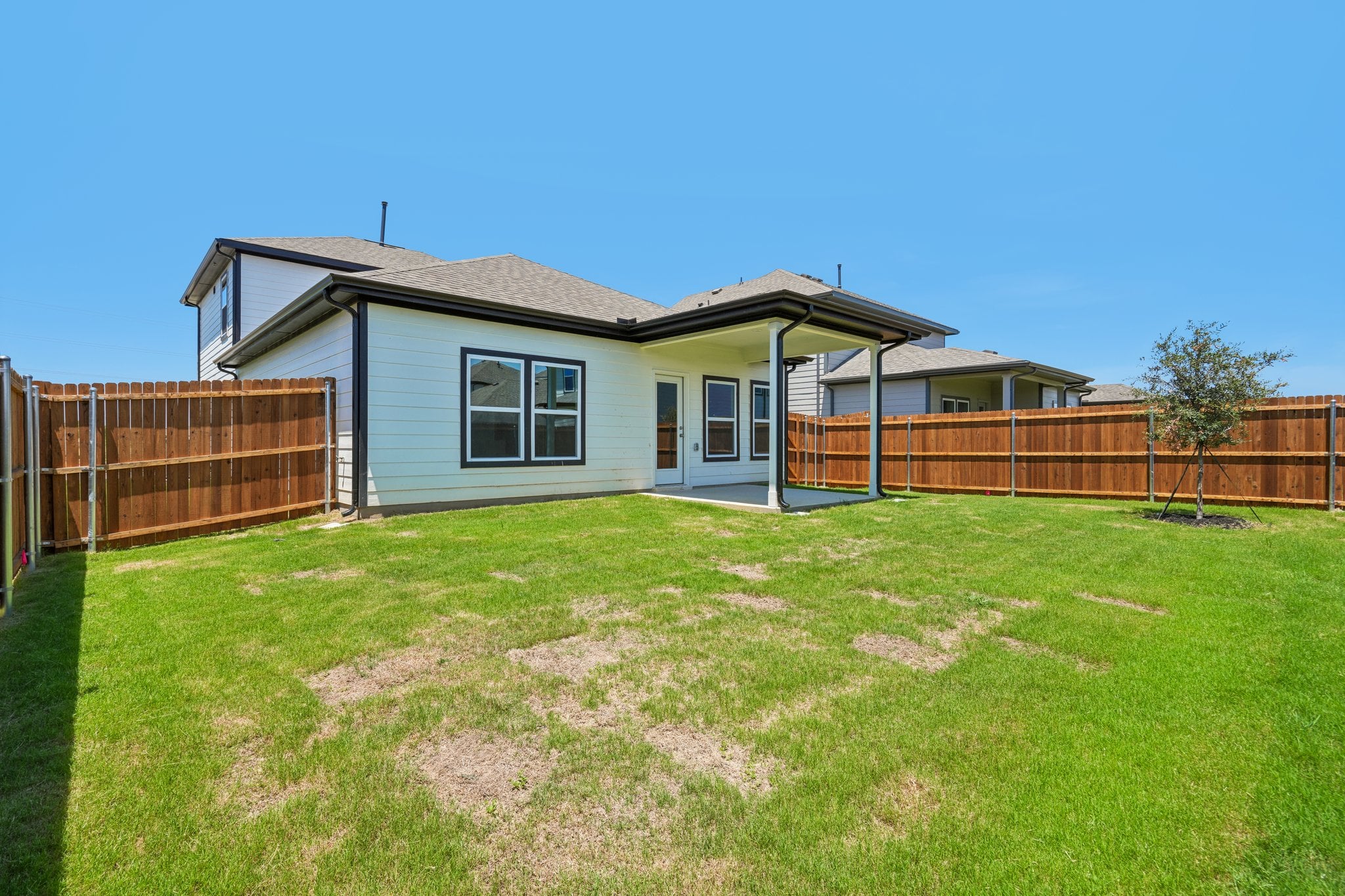 A house with a fence and grass.