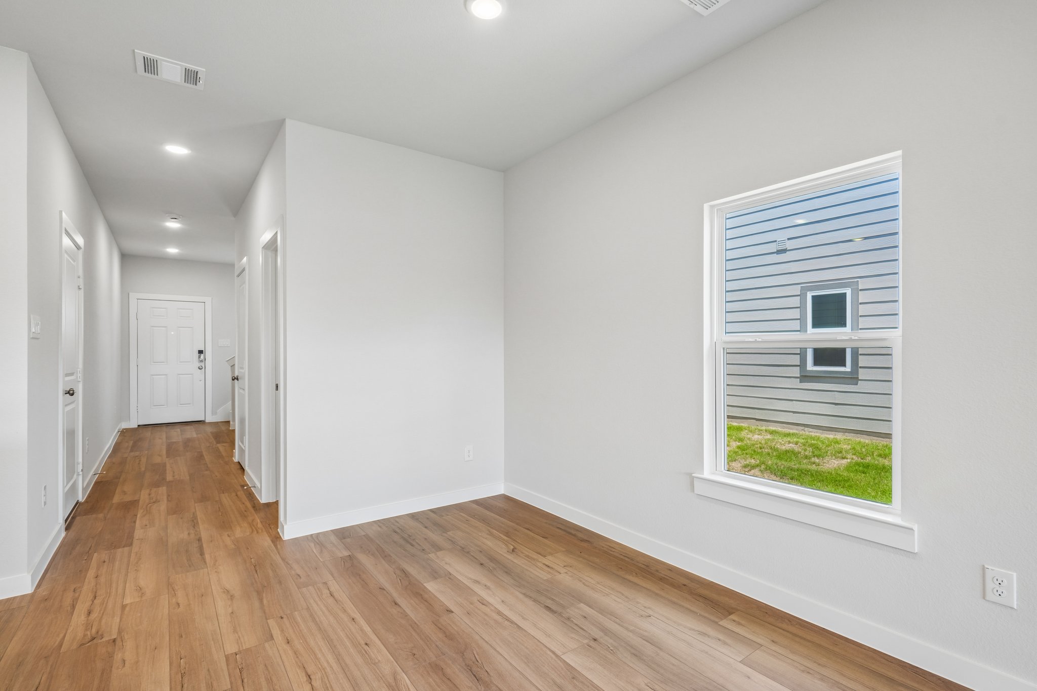 A room with white walls and a wood floor.
