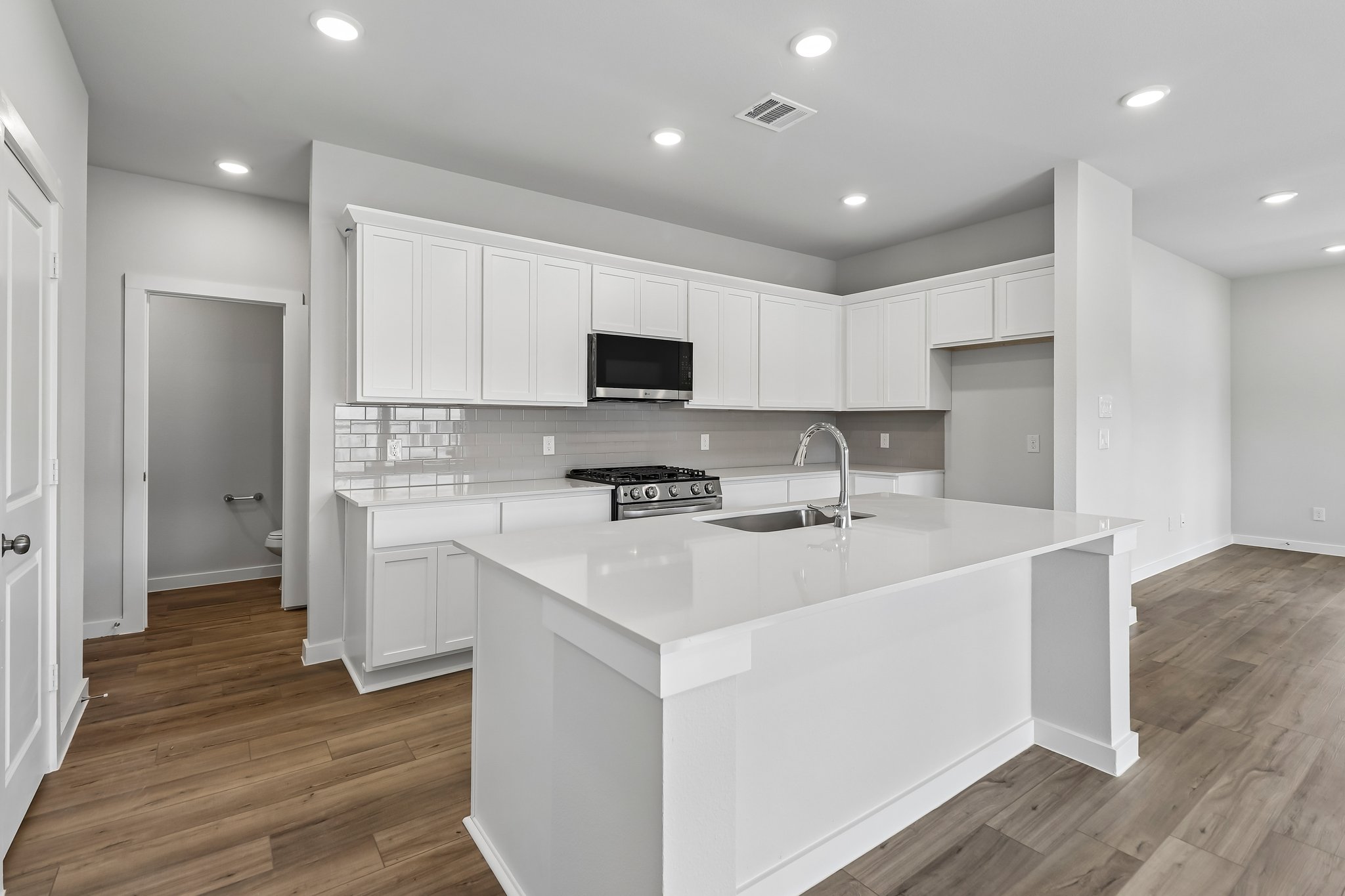 A kitchen with white cabinets.