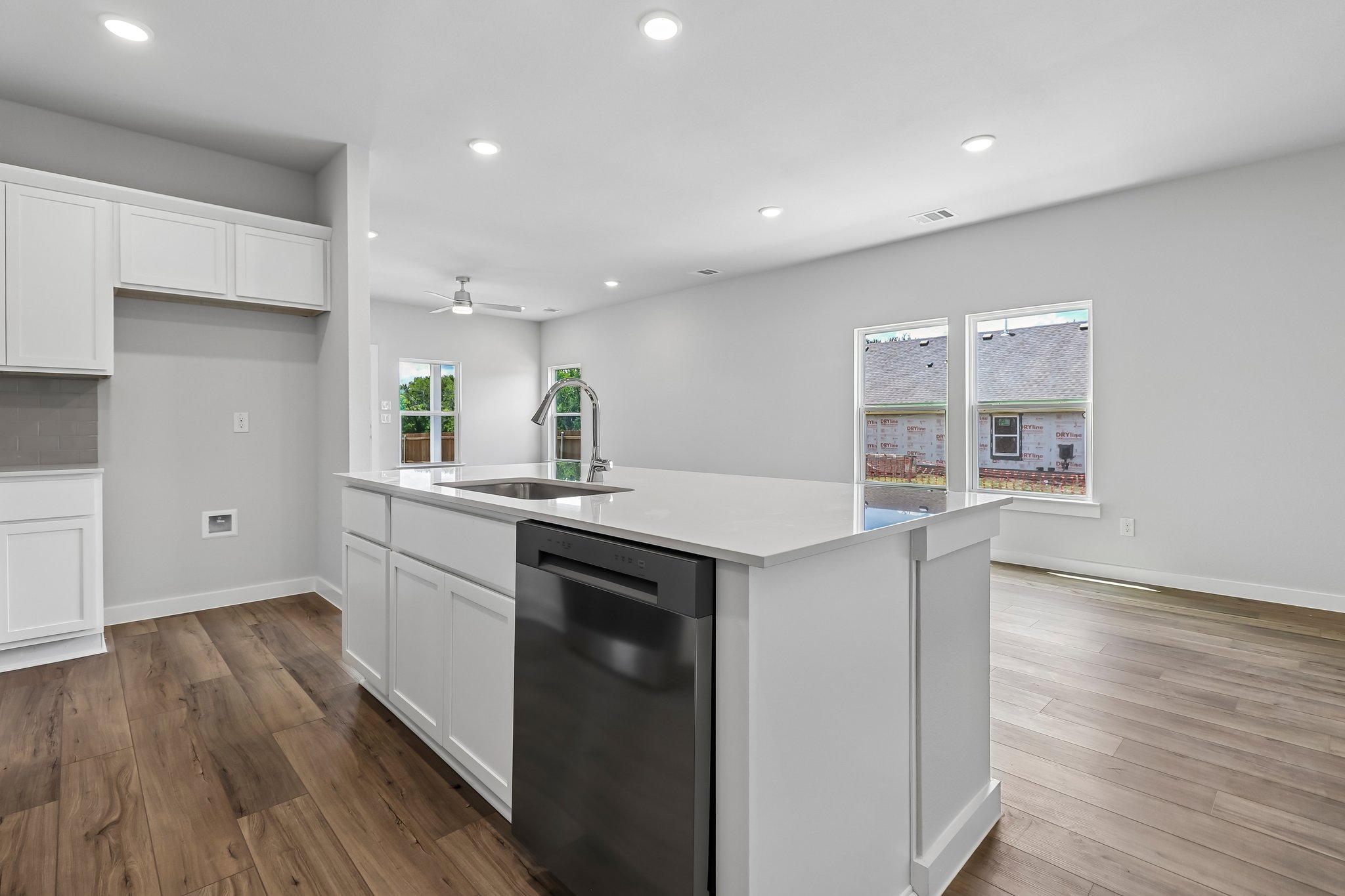 A kitchen with white cabinets.