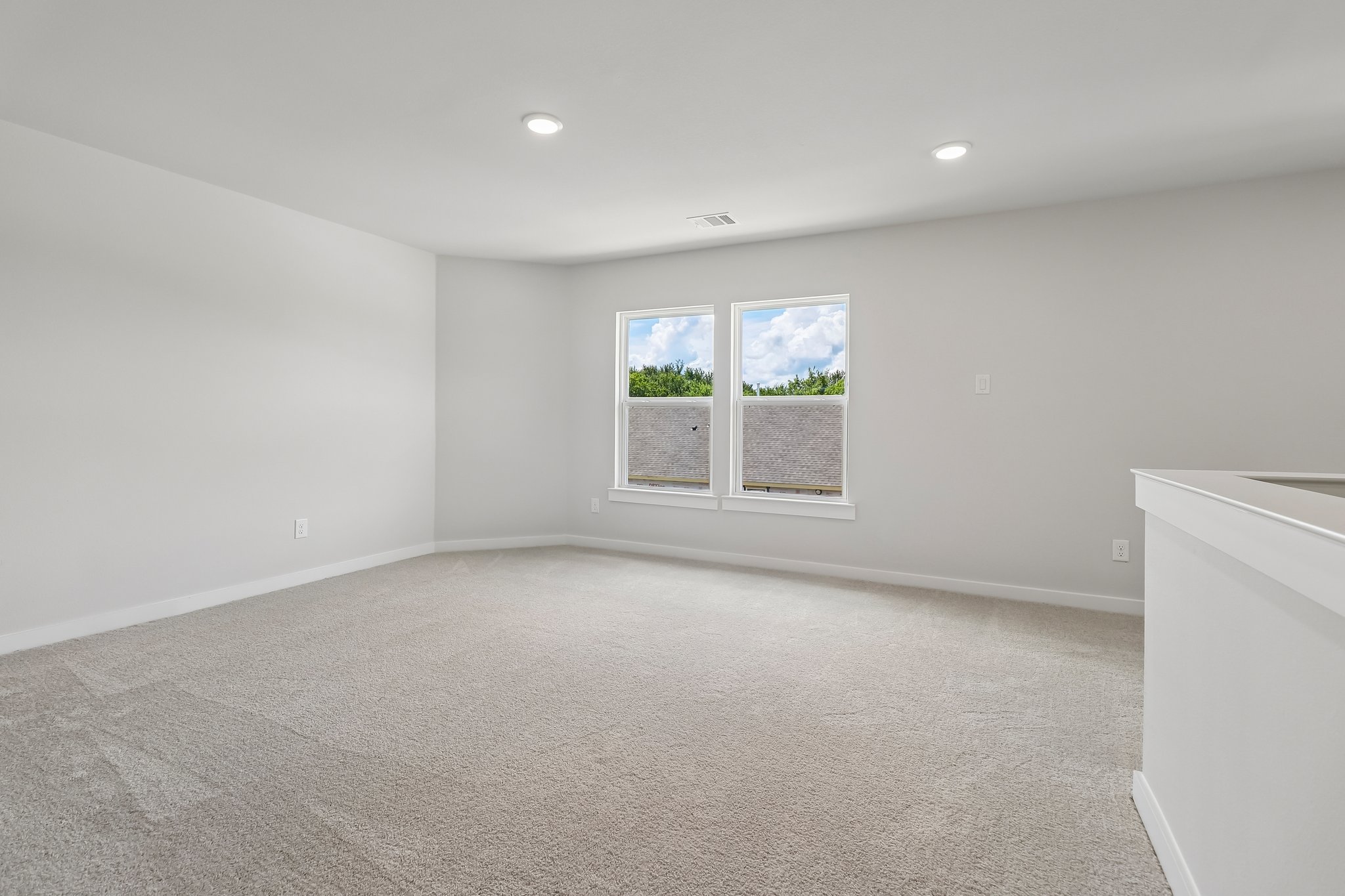 A room with a window and a carpet.
