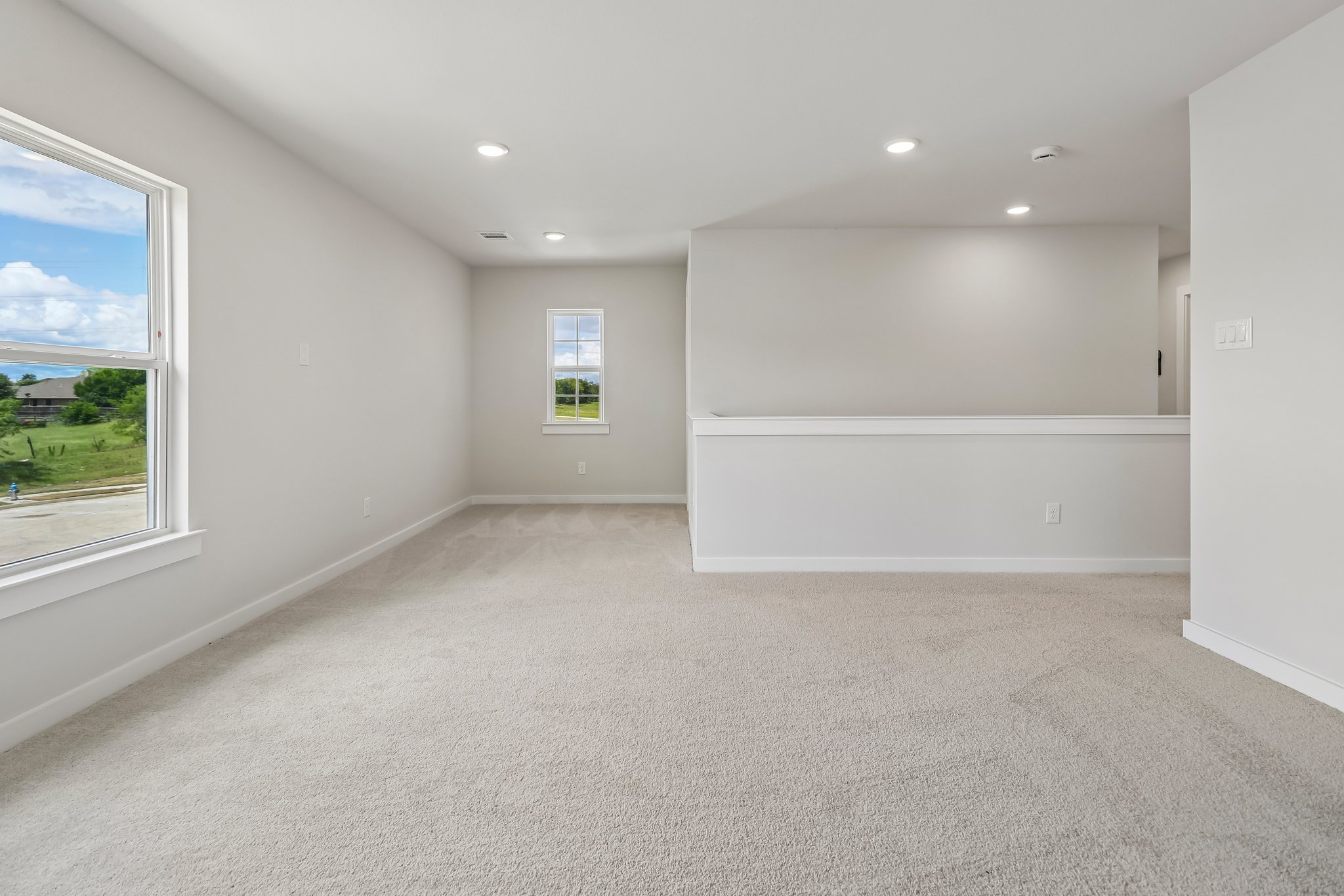 A room with a white wall and a window.