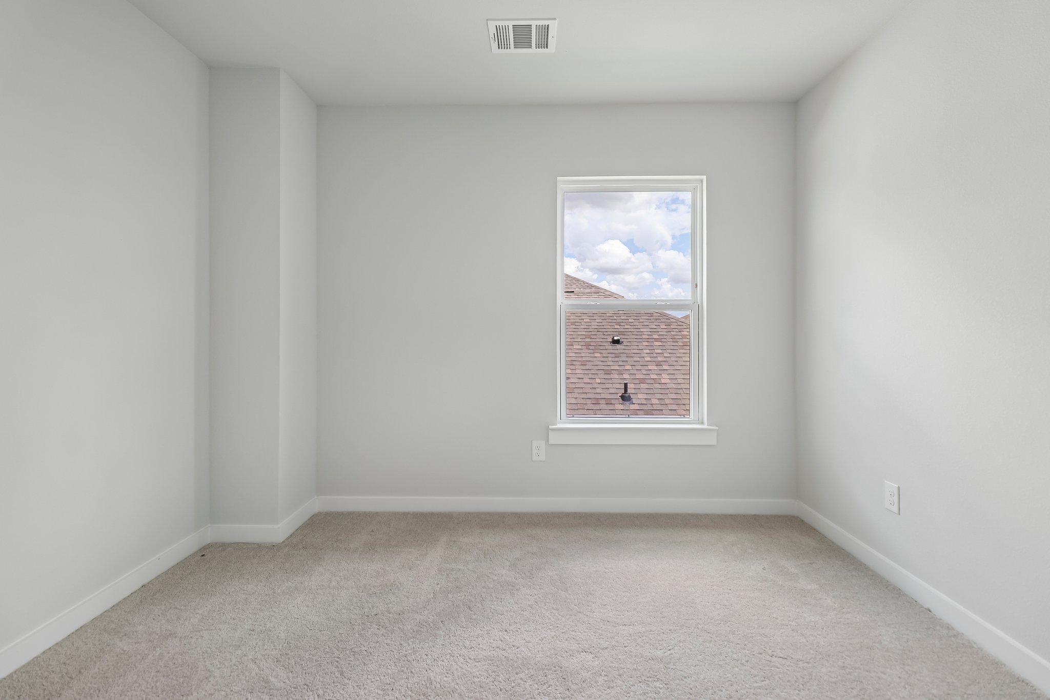 A white room with a window.