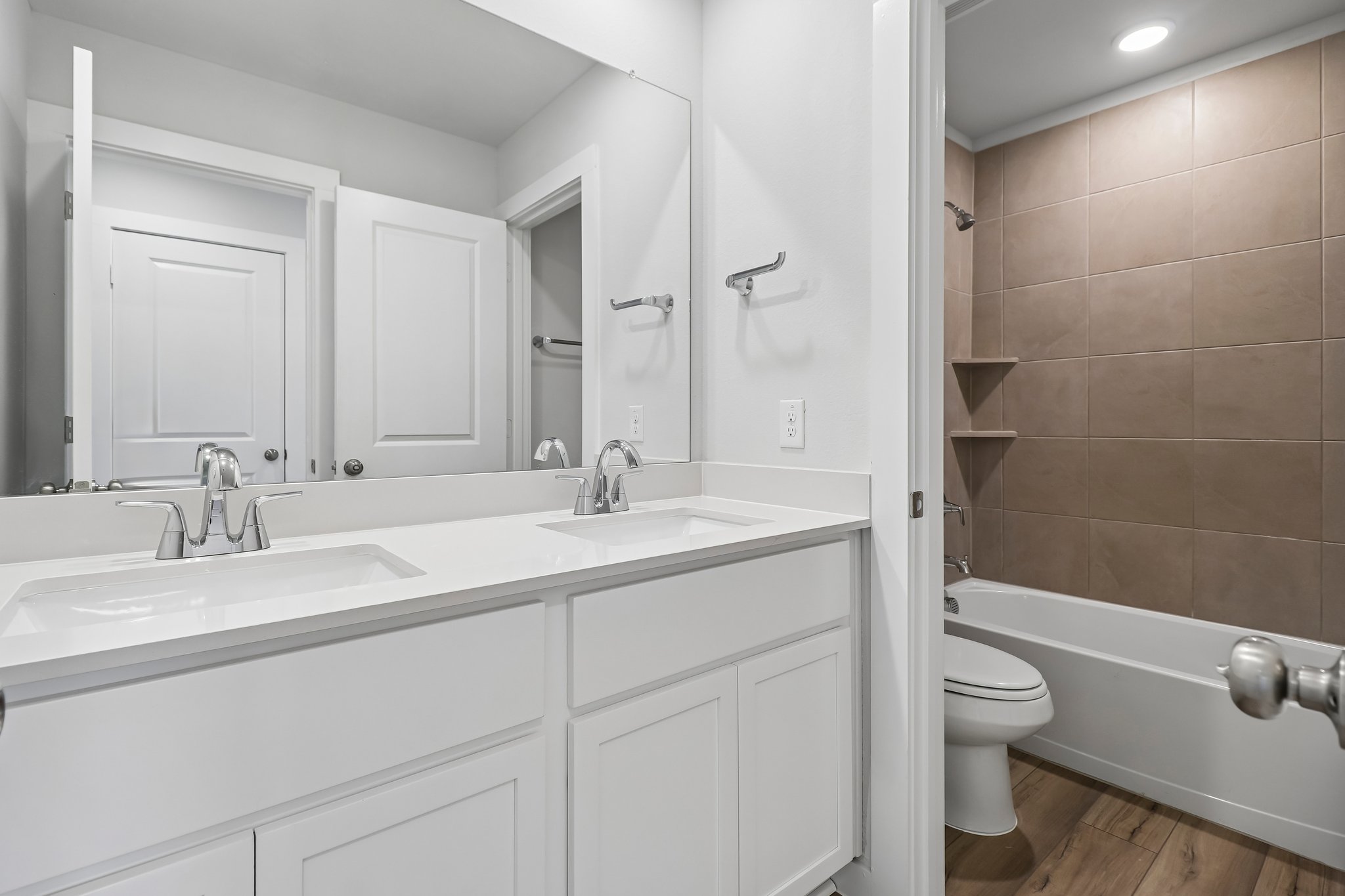 A bathroom with a tub sink and toilet.