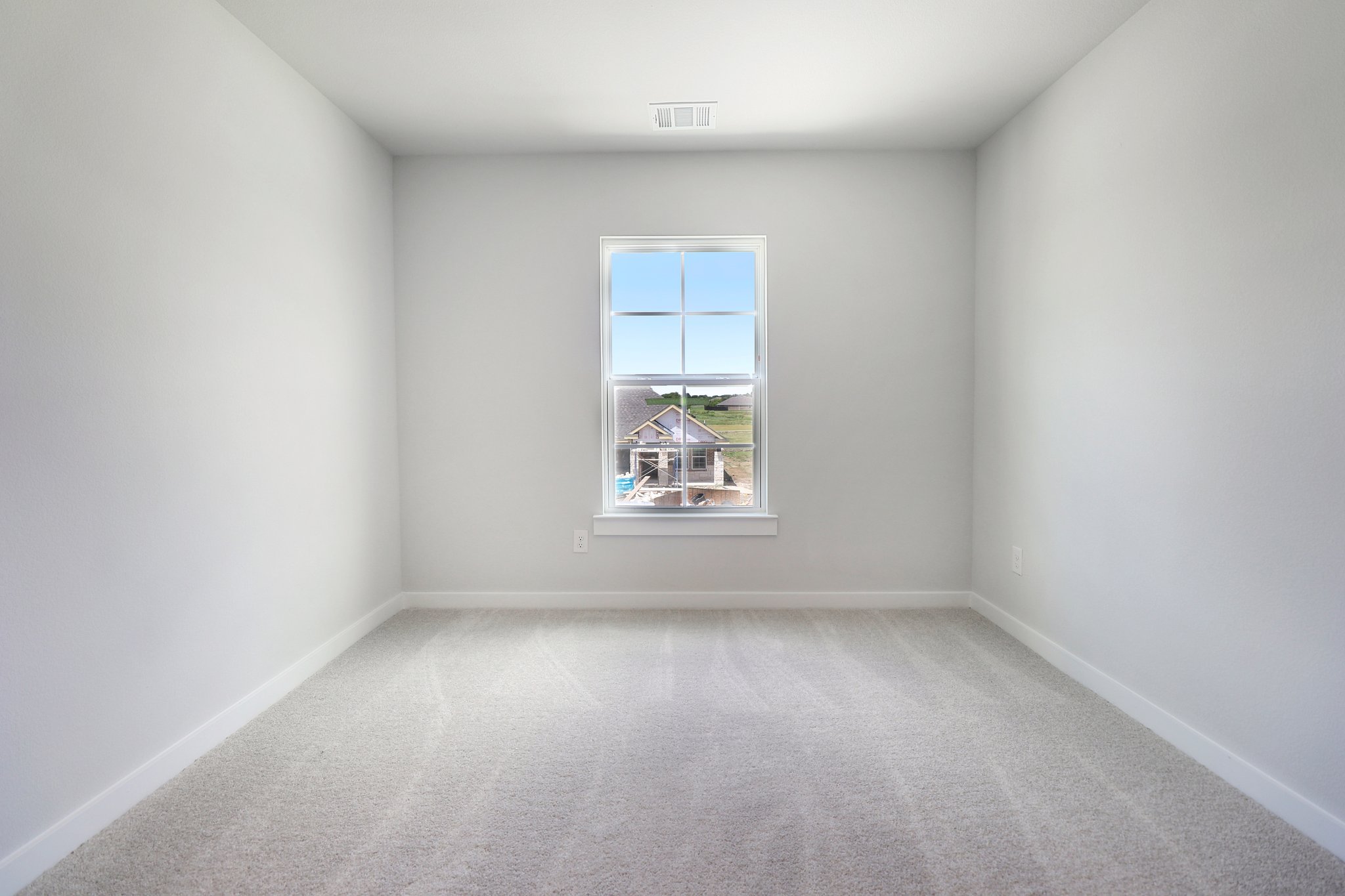 A room with a window and a plant in it.