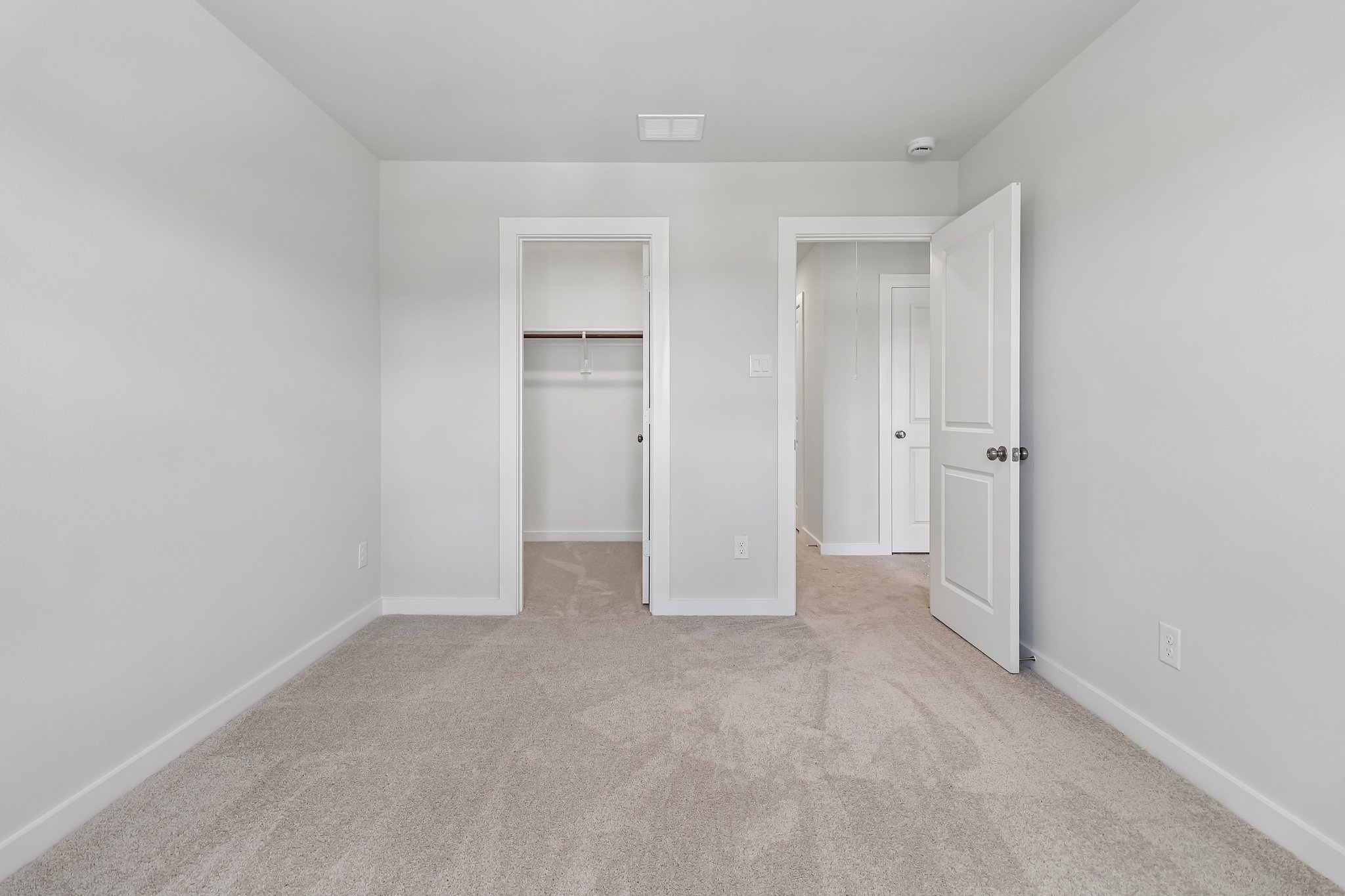 A hallway with white doors.
