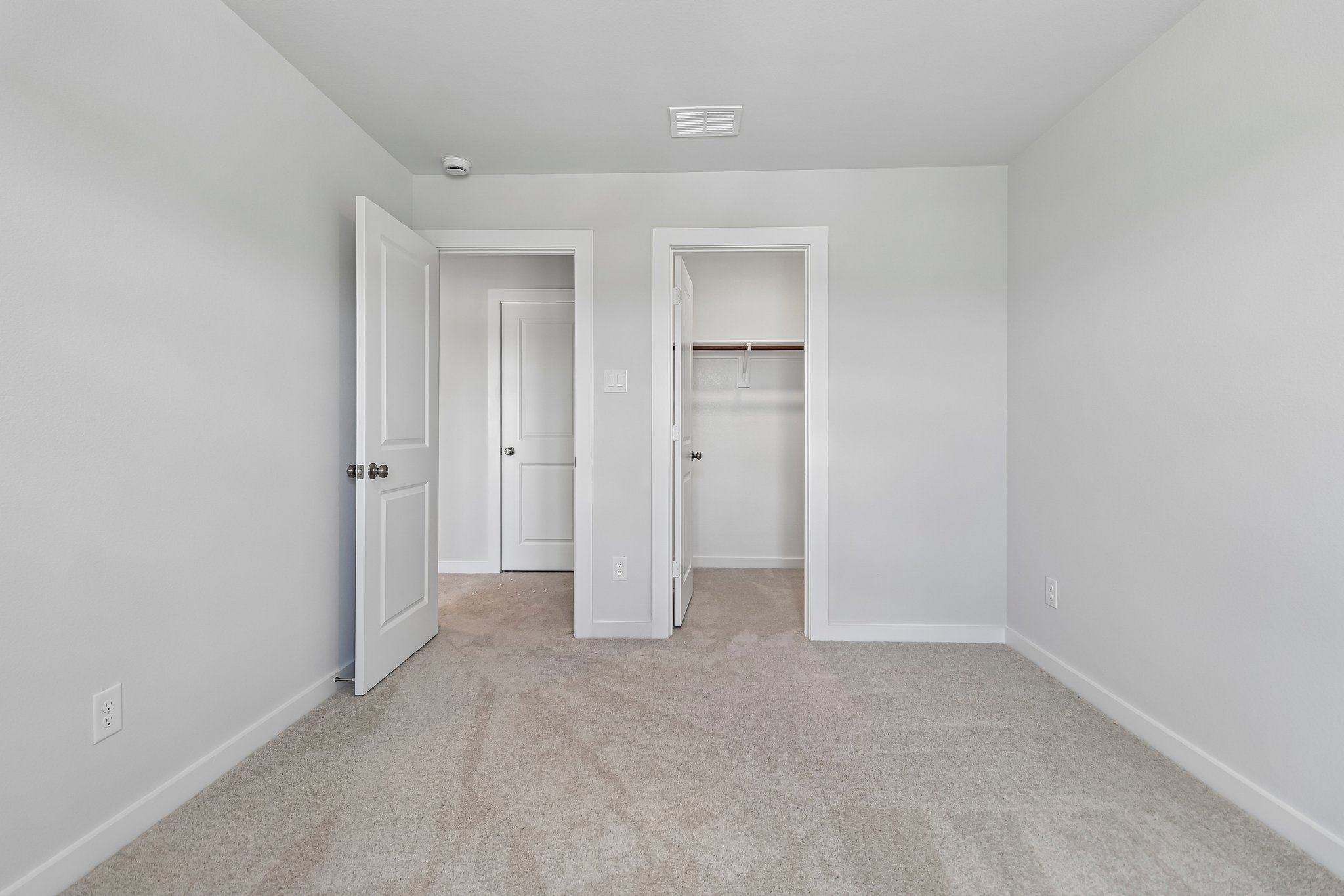 A hallway with white doors.