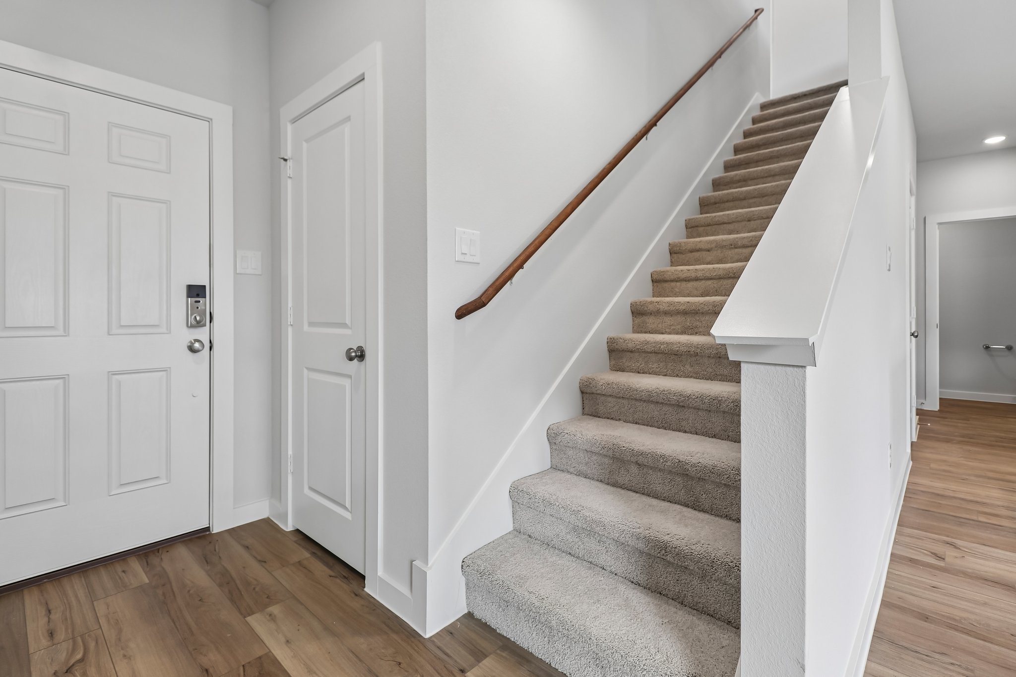 A staircase with white doors.