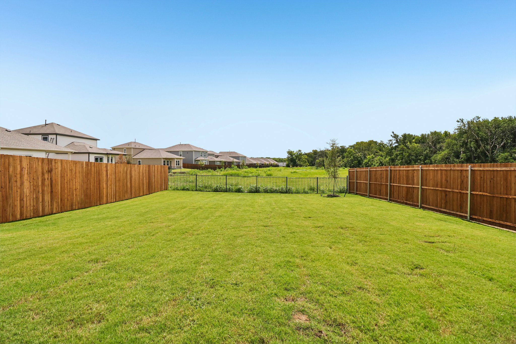 A fenced in grass field.