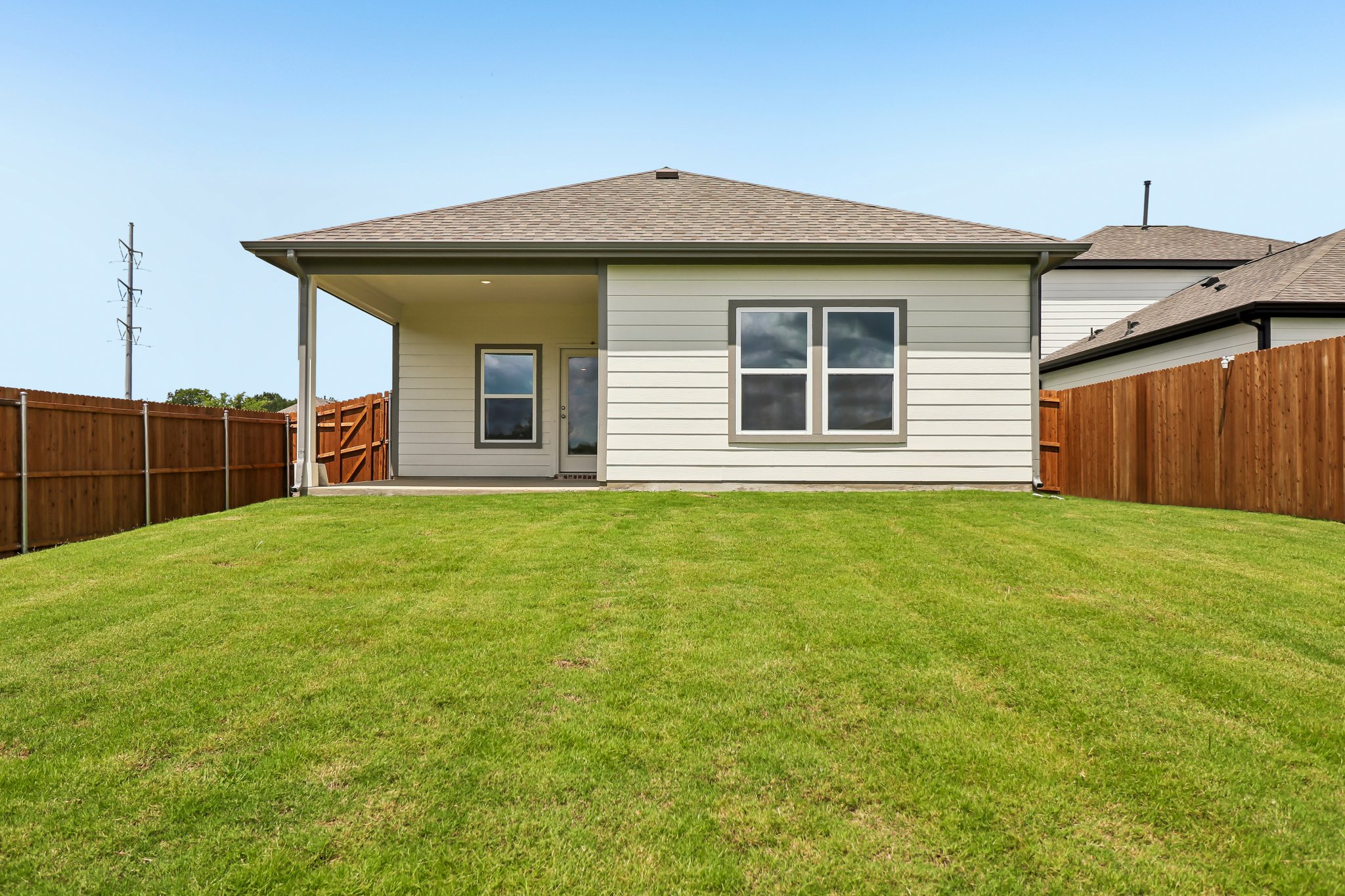 A house with a fence and grass.