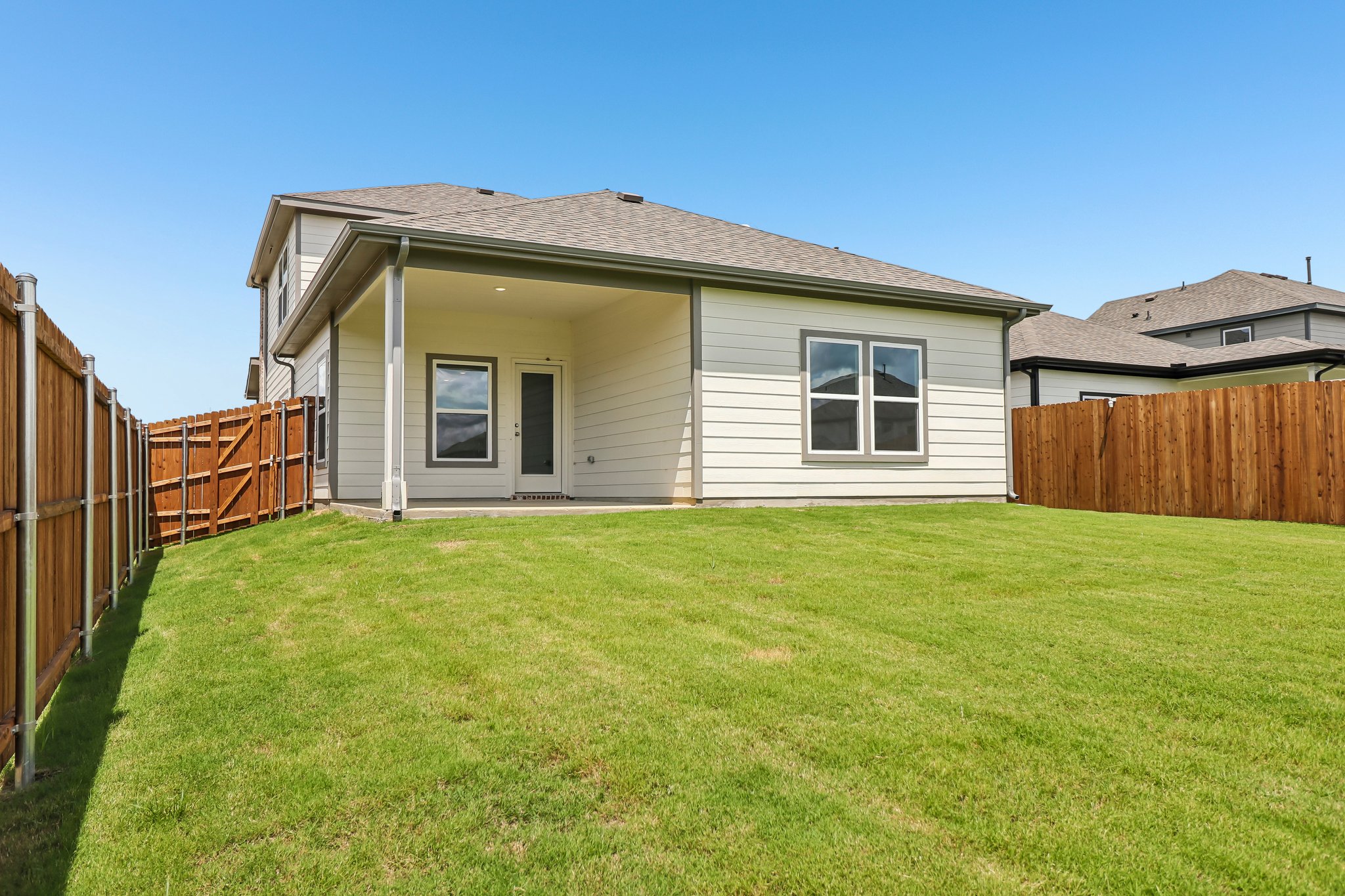 A house with a fence and grass.