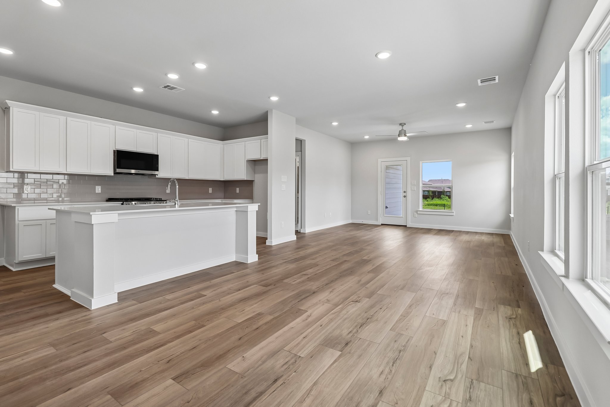 A large kitchen with white cabinets.
