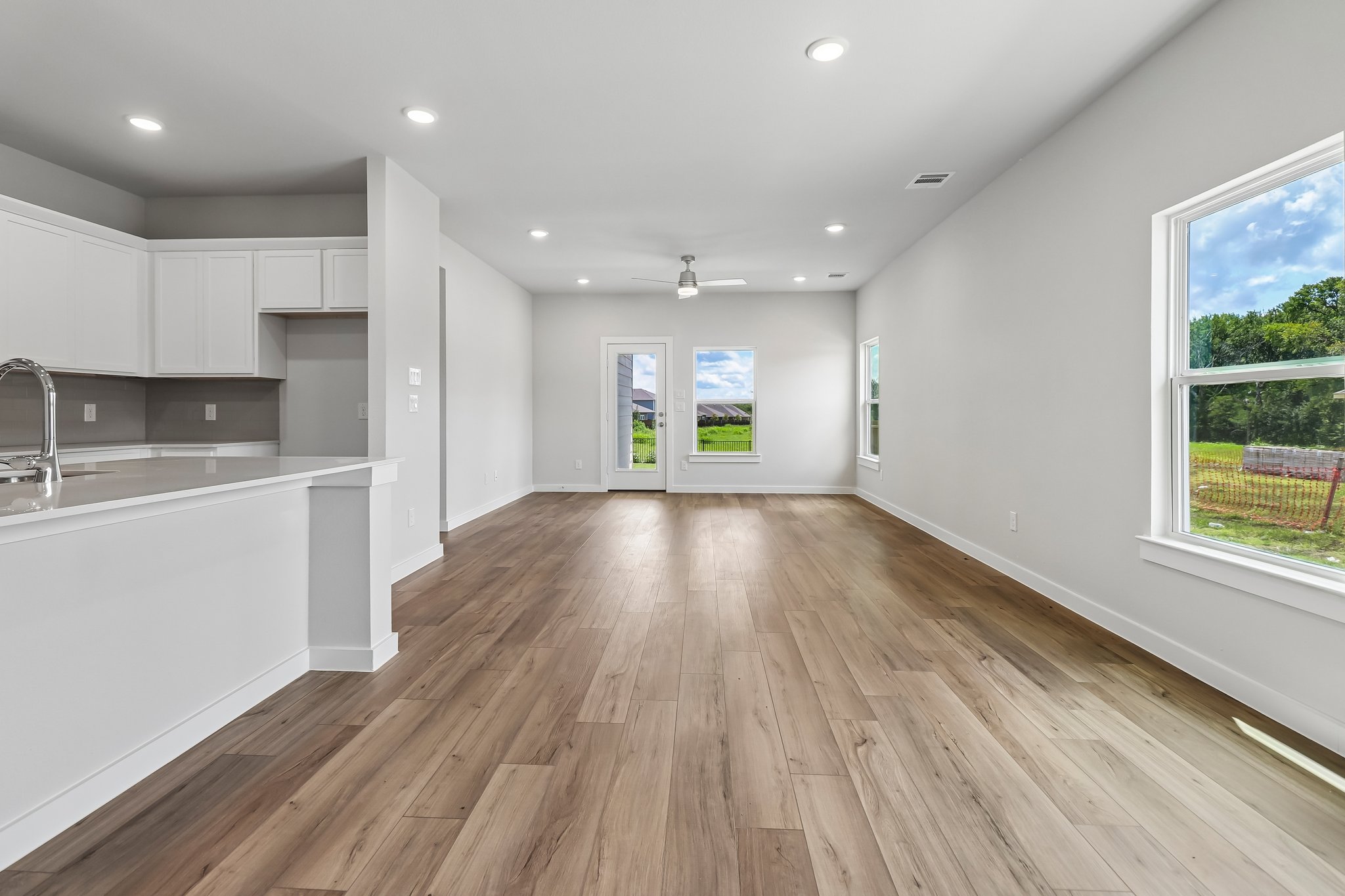 A kitchen with white cabinets.
