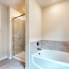 Tub and Shower at Owner's Bath of 263 Fire Rock at Ambergrove by Century Communities