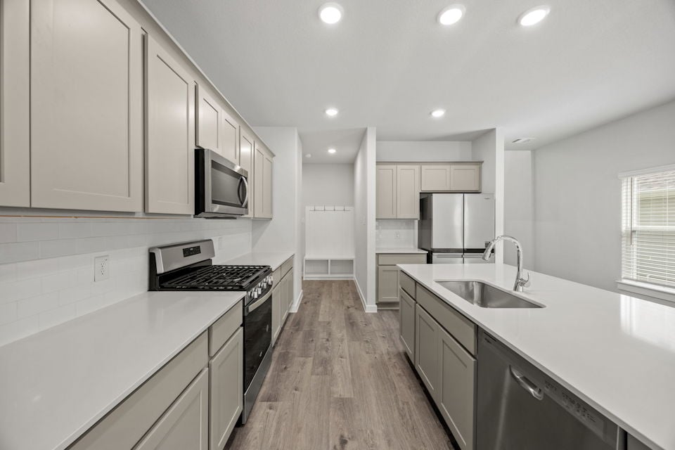 A kitchen with white cabinets.