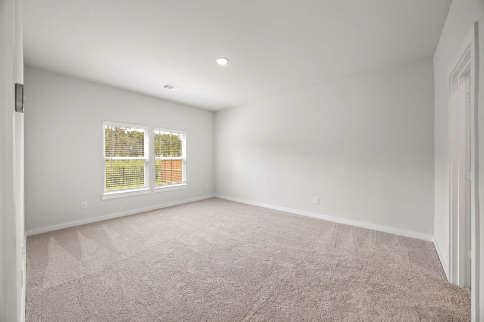 A room with a window and carpet.