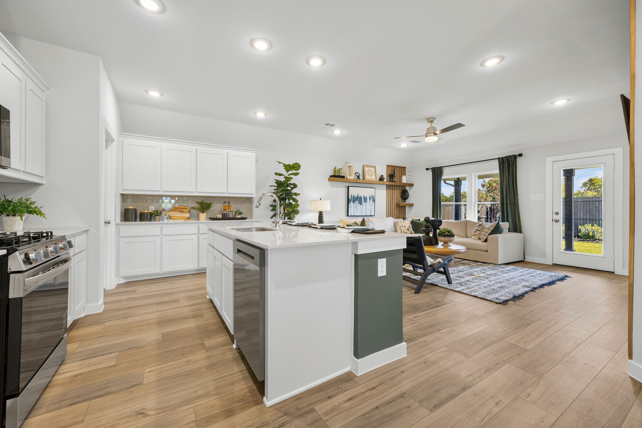 A kitchen with white cabinets.