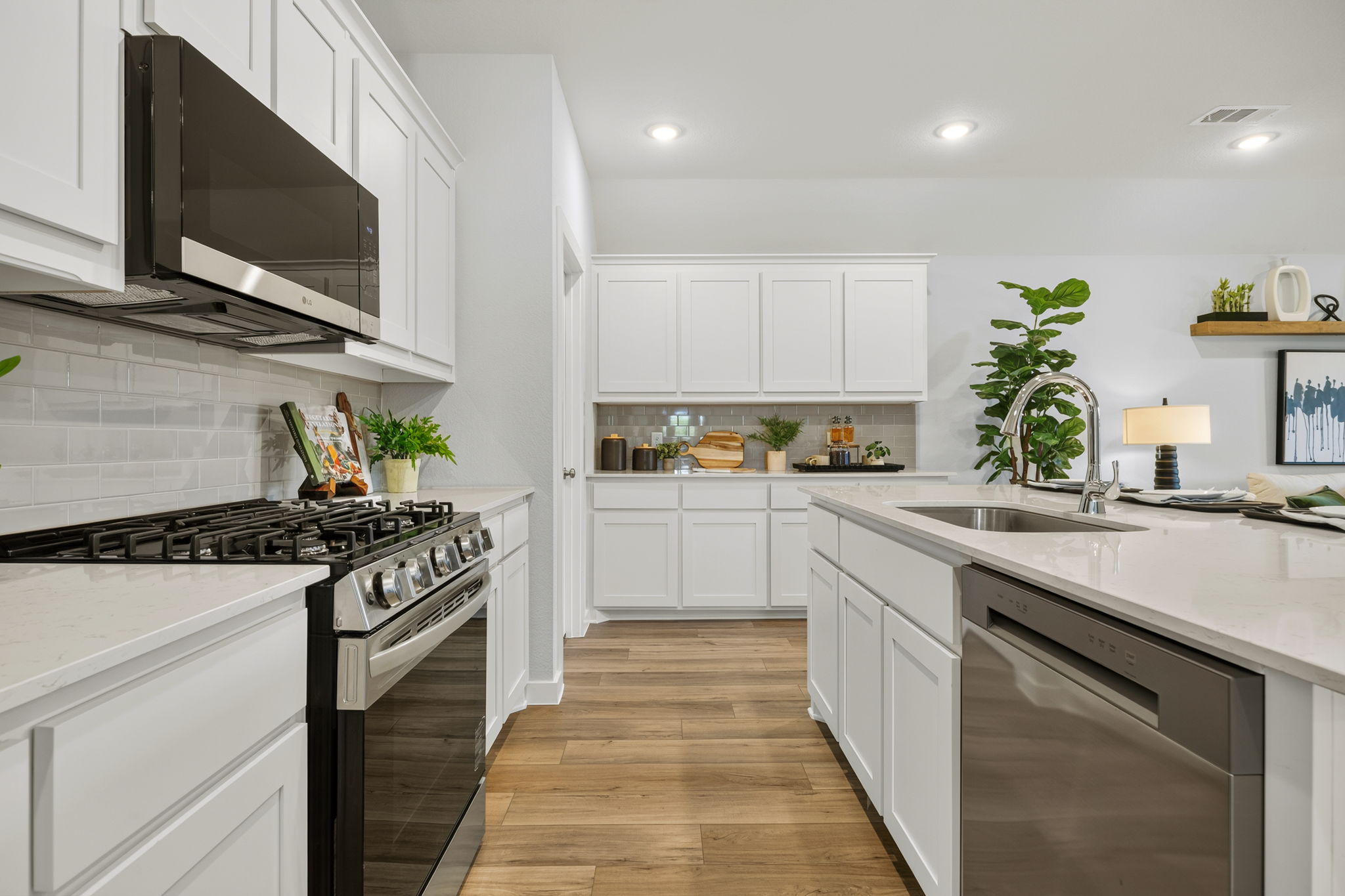 A kitchen with white cabinets.