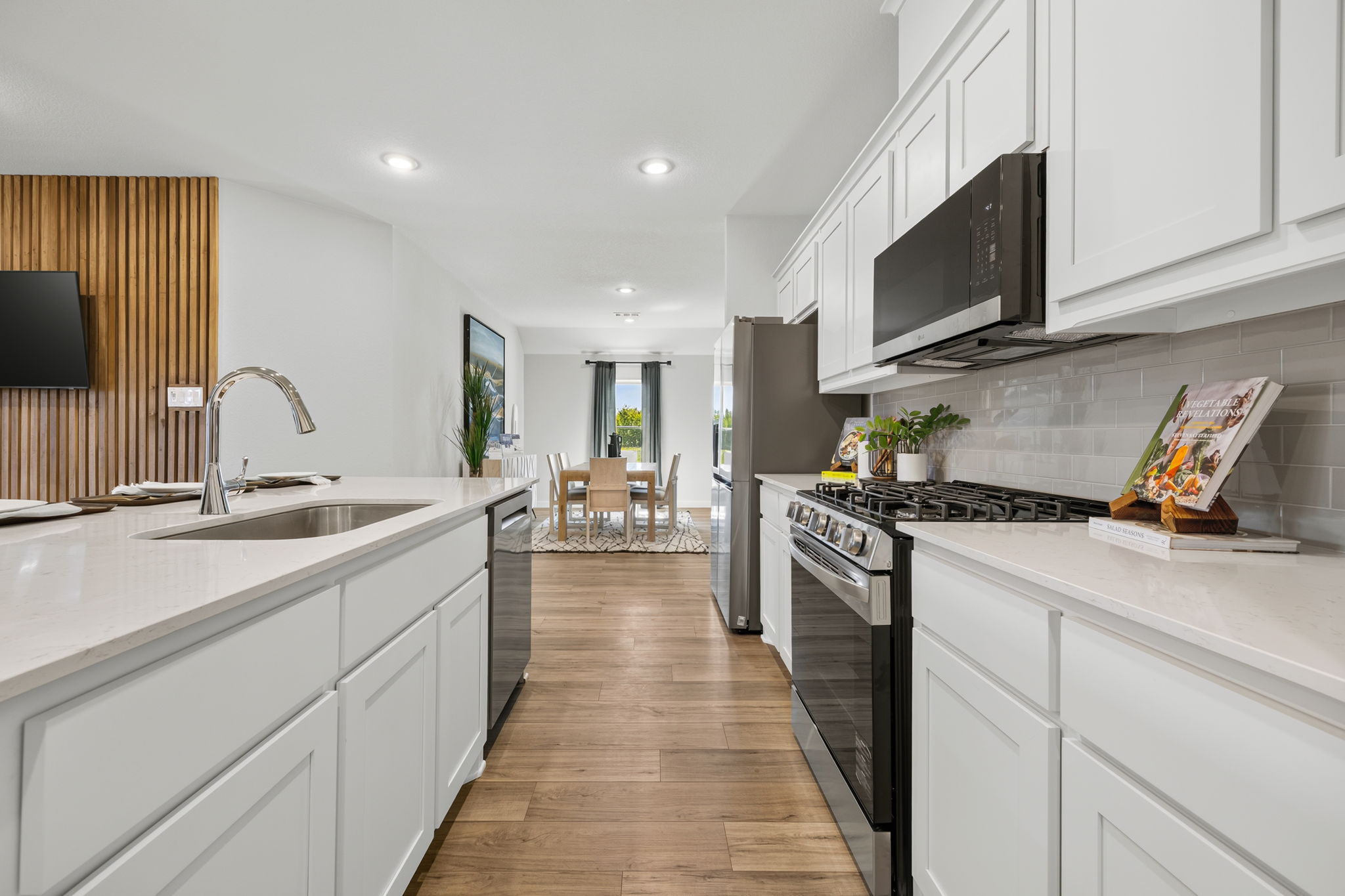 A kitchen with white cabinets.