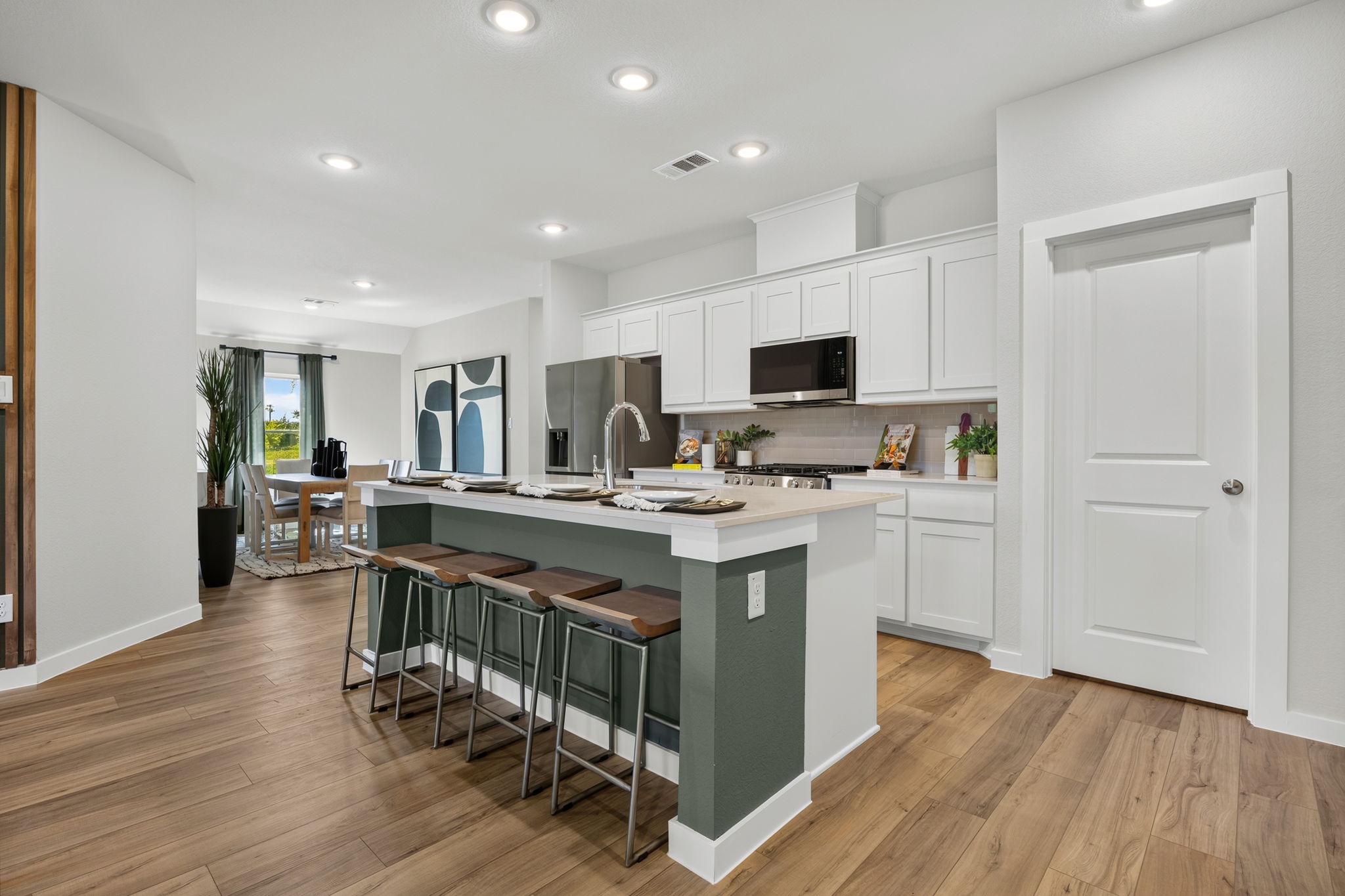A kitchen with white cabinets.