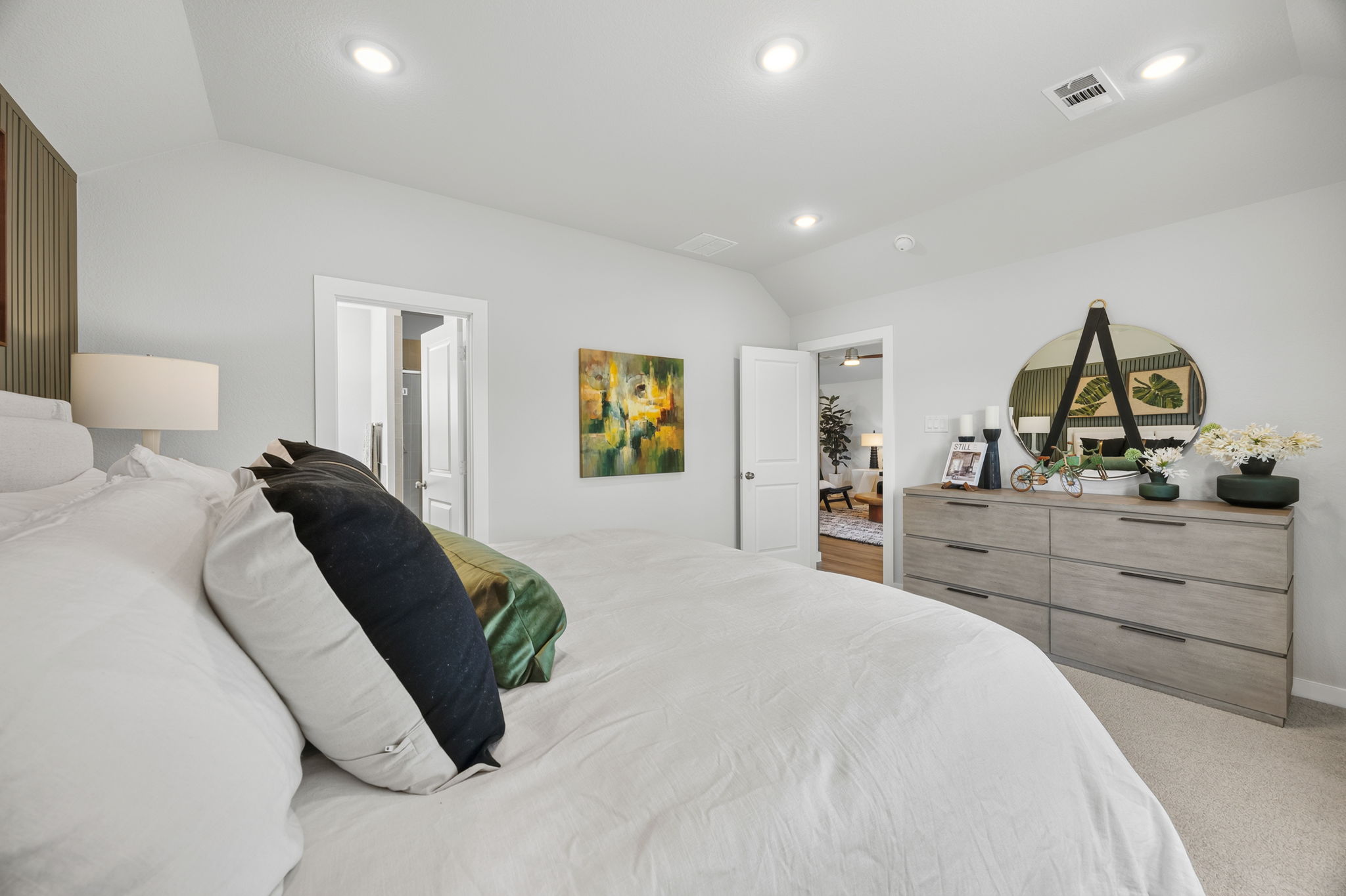 A bedroom with a bed and a dresser.