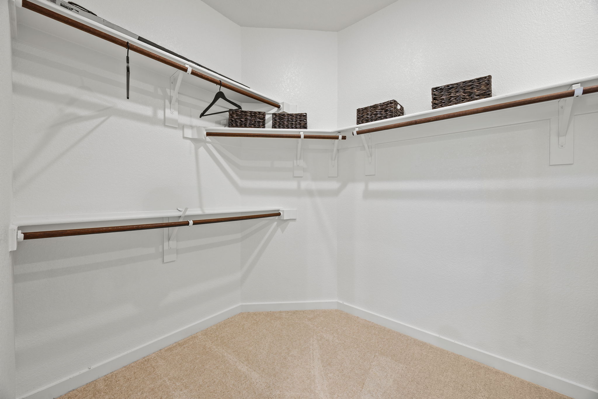 A white staircase with a rug.