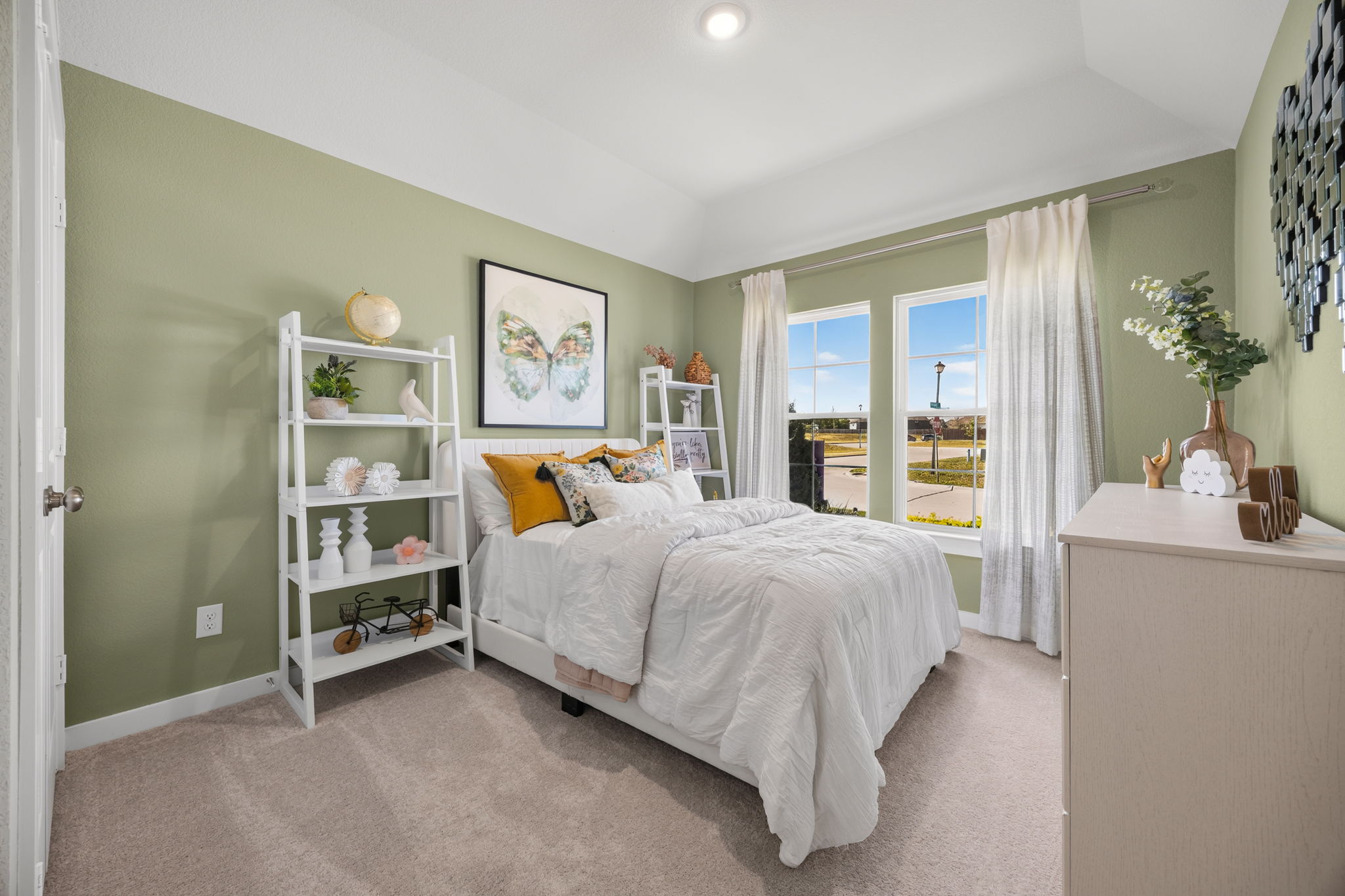 A bedroom with a bed and a bookcase.