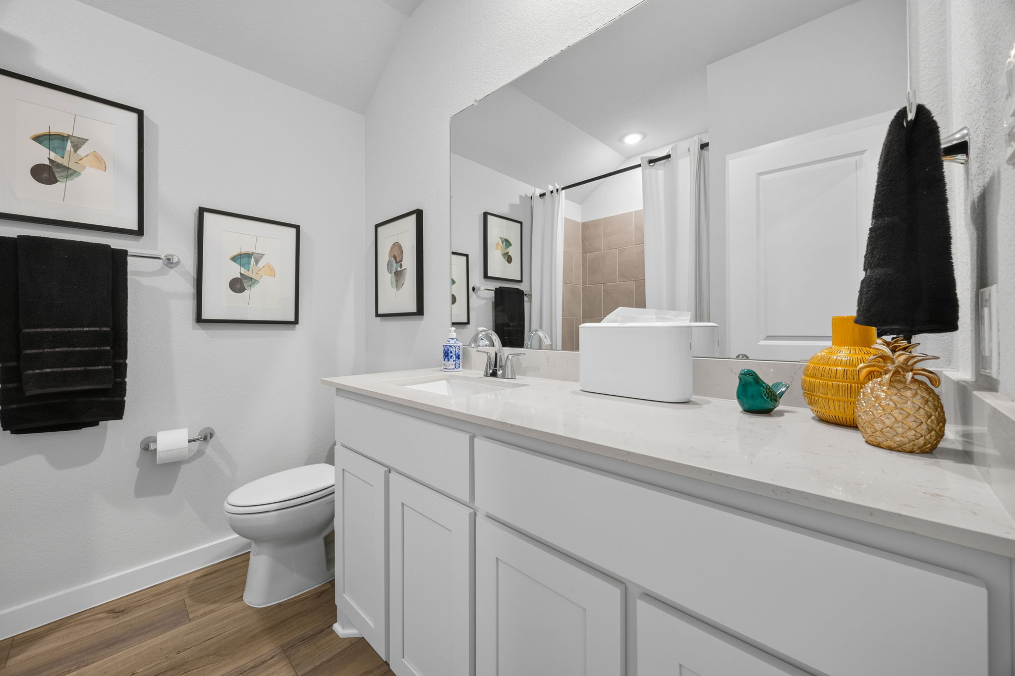A bathroom with a large mirror.