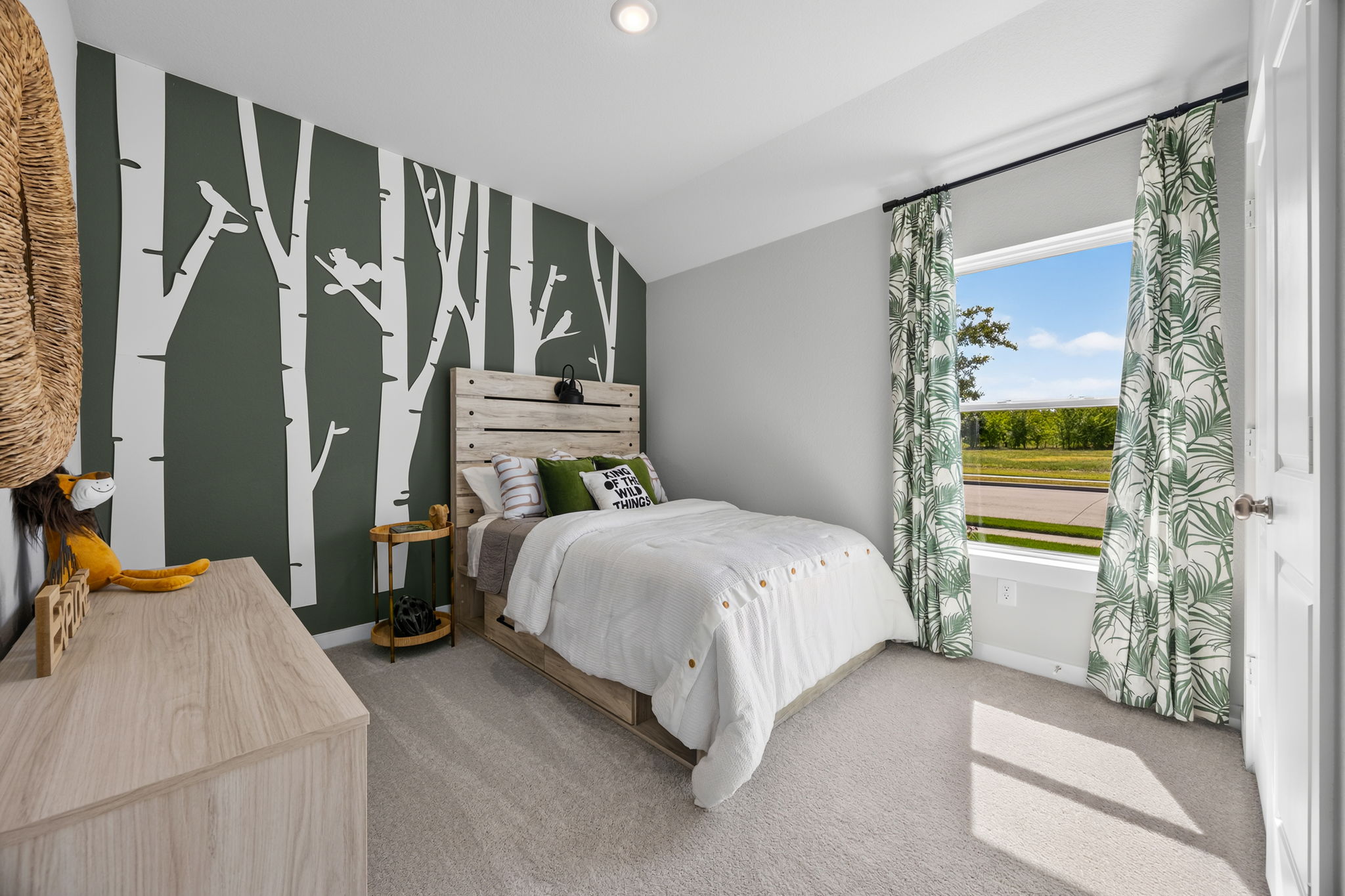 A bedroom with a large window.