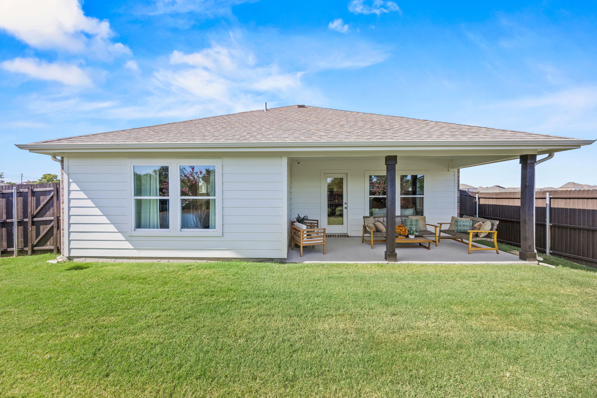 A house with a lawn and chairs.