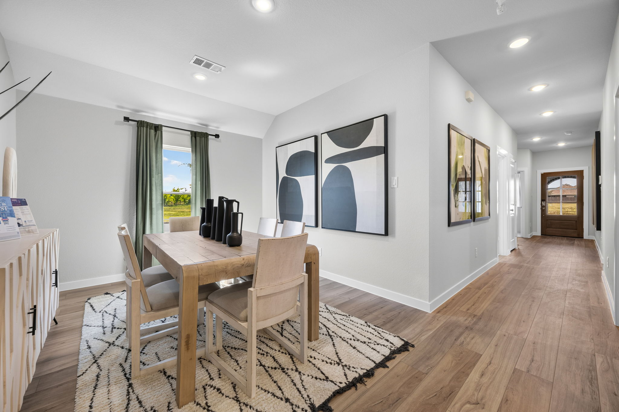 A dining room with a wood floor.