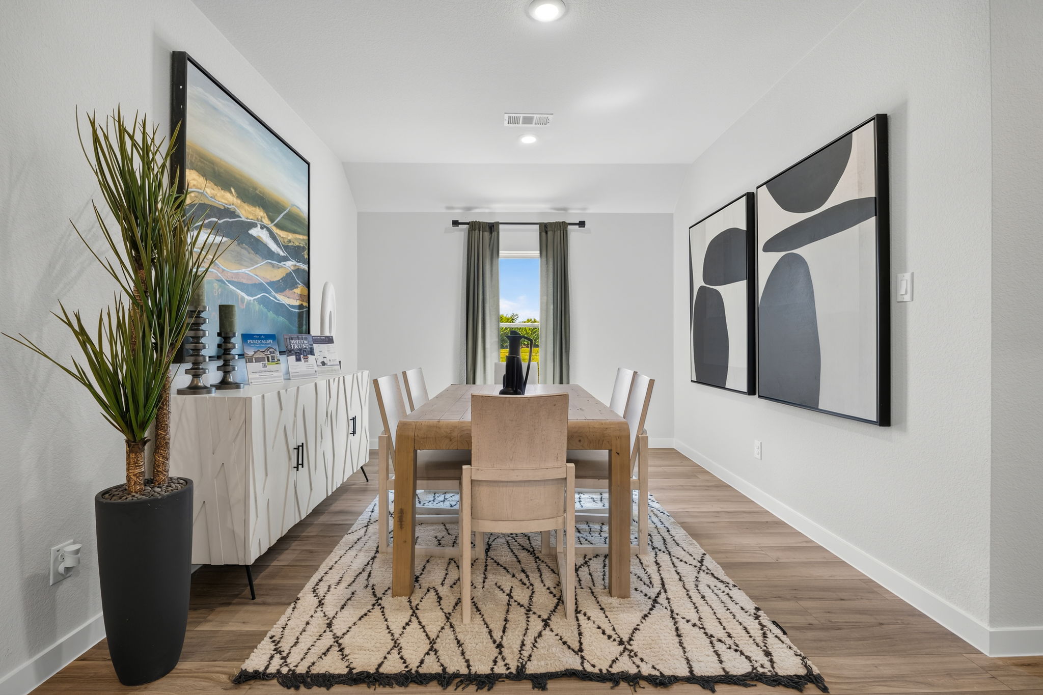 A dining room with a table and chairs.