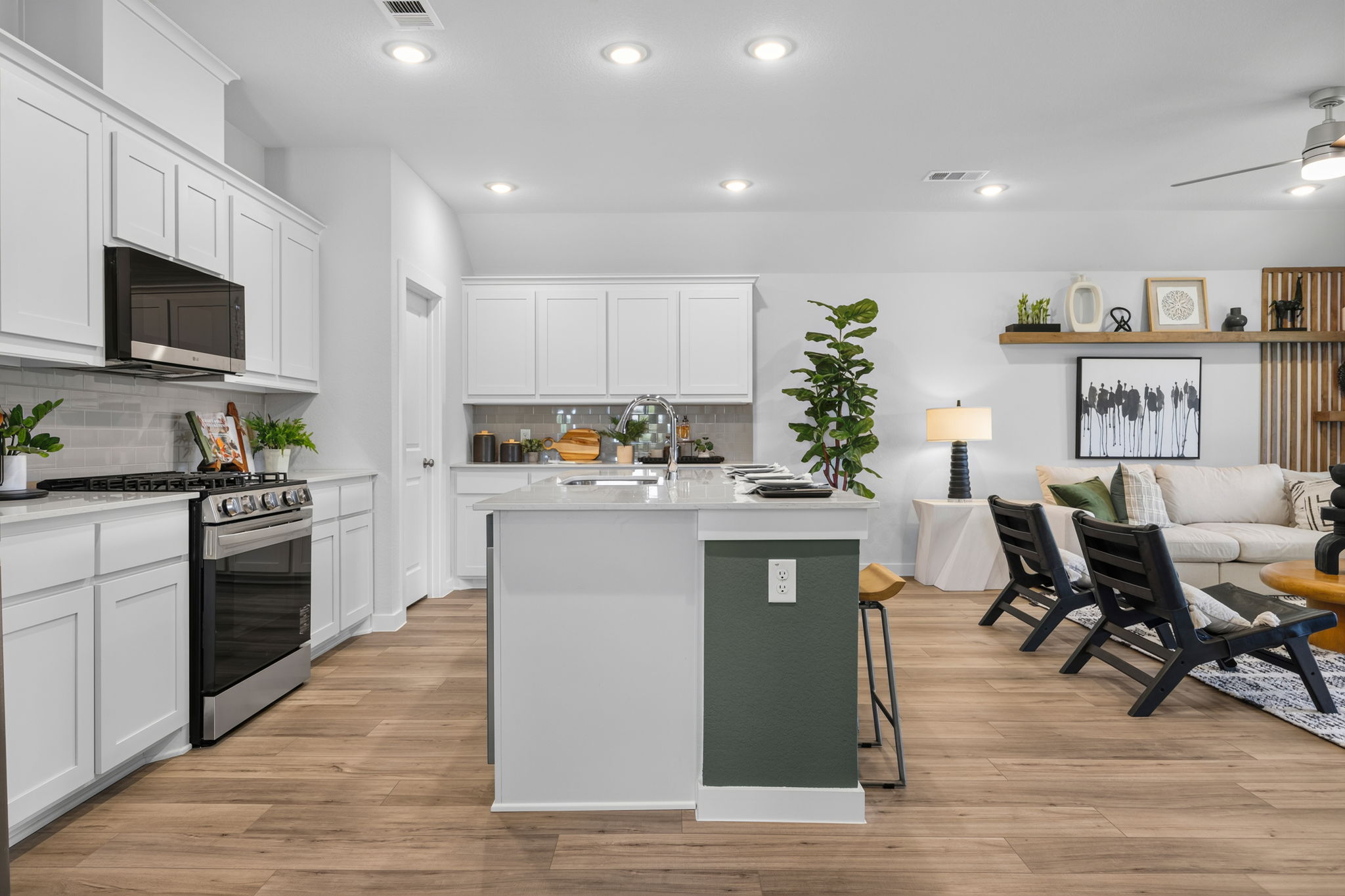 A kitchen with white cabinets.